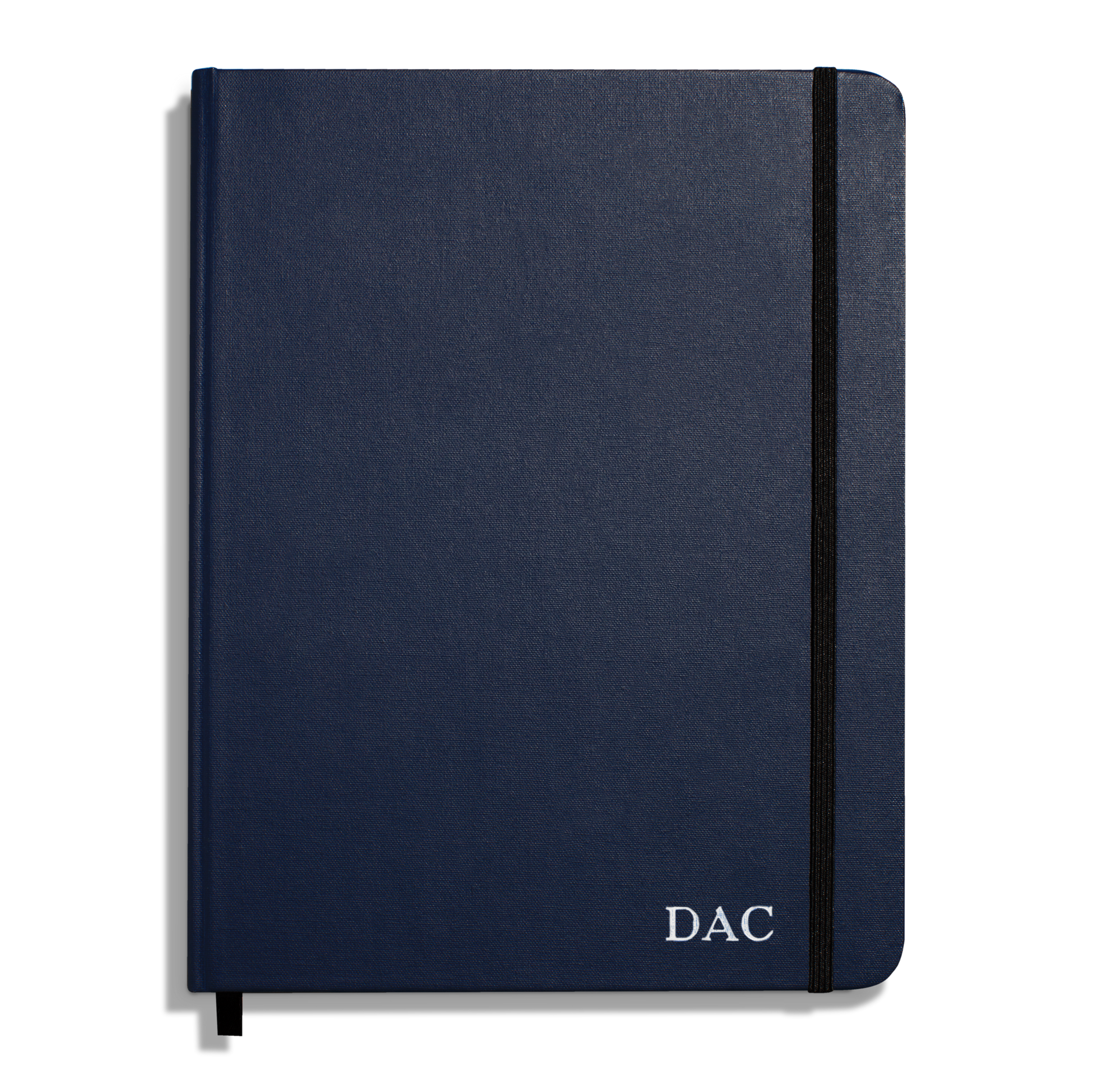 The Shinola Large Hard Ruled Journal in navy features a black elastic band and white "DAC" initials printed on the bottom right corner of the cover.