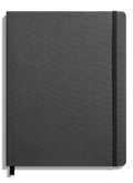 The Shinola Large Soft Ruled Journal in Charcoal features a textured fabric cover, smyth-sewn binding for durability, a black elastic closure on the right side, and a black ribbon bookmark at the bottom.