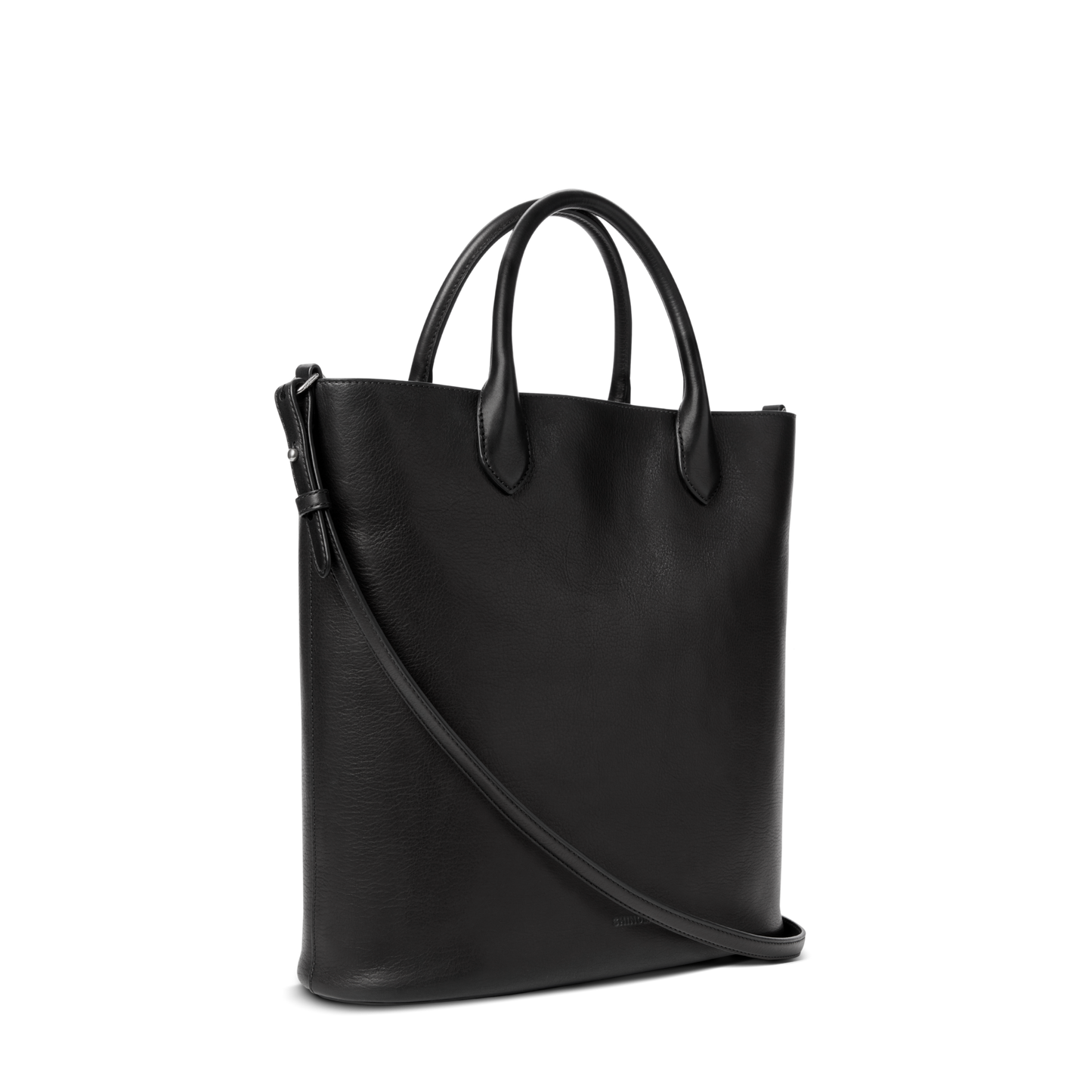 The Shinola 12 Hour Tote Bag - Black is a sleek leather tote with dual short handles and a long adjustable strap, shown upright on a white background—ideal as your versatile everyday bag.