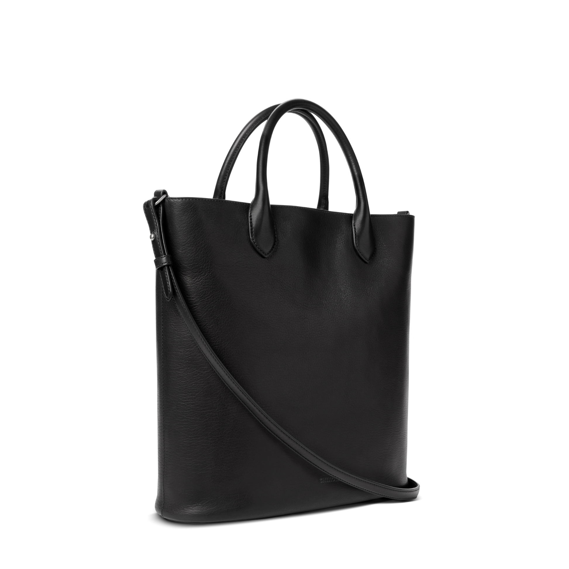 The Shinola 12 Hour Tote Bag - Black is a sleek leather tote with dual short handles and a long adjustable strap, shown upright on a white background—ideal as your versatile everyday bag.