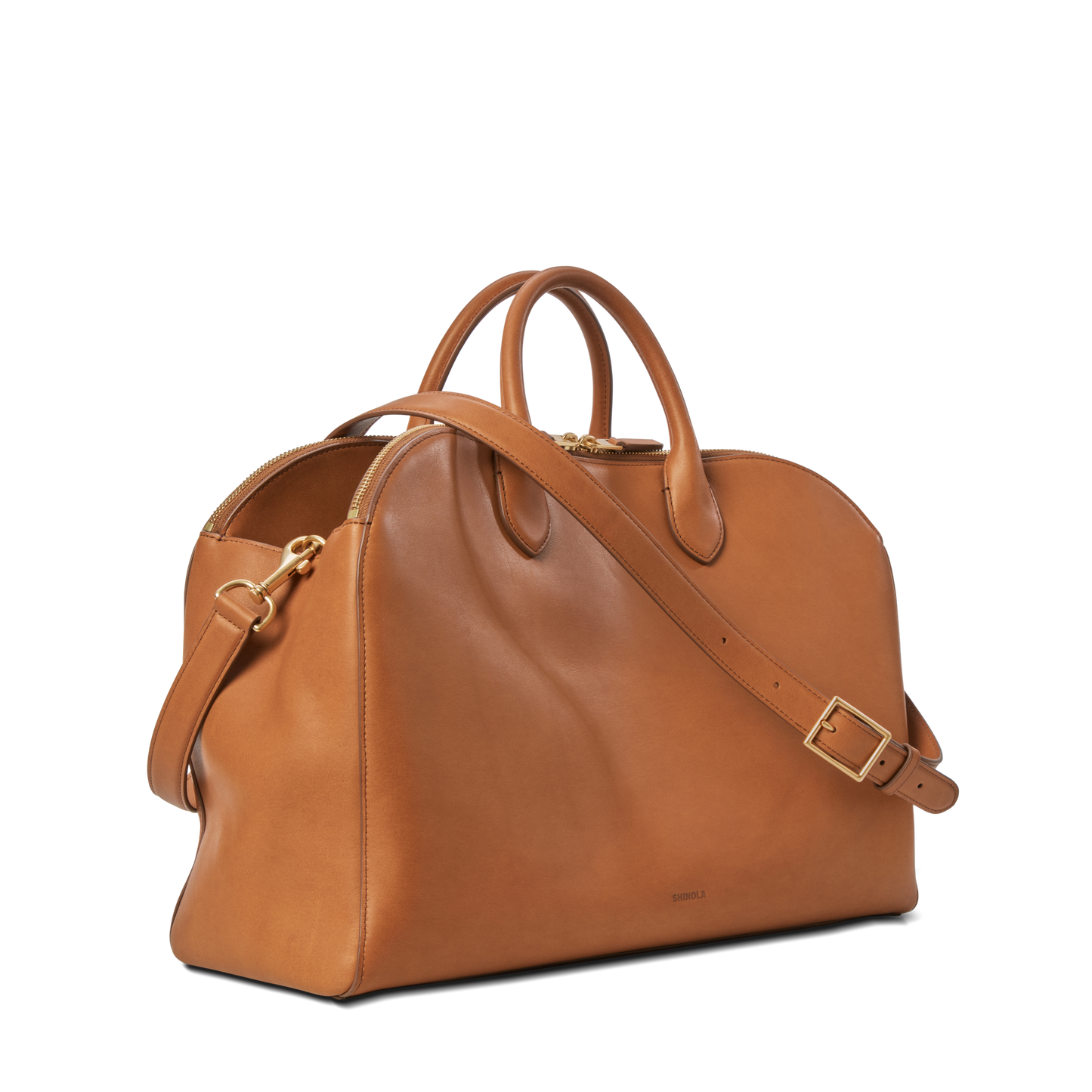 The Shinola Bixby Work Satchel - Tan is a spacious, structured leather bag with dual handles, a removable shoulder strap, and gold-tone hardware—ideal as a stylish laptop bag—shown on a plain white background.