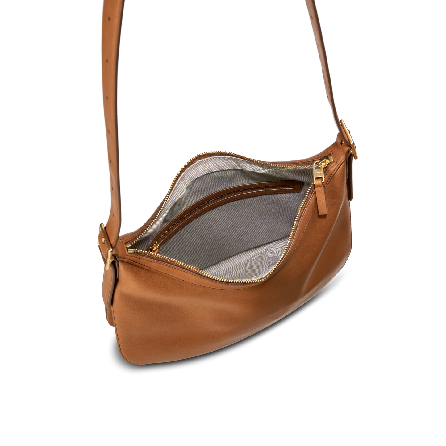 The Shinola Medium Bixby Crossbody - Tan is a natural leather shoulder bag with a gold zipper, shown open to display its light gray fabric lining and inner zippered pocket, set against a plain white background.
