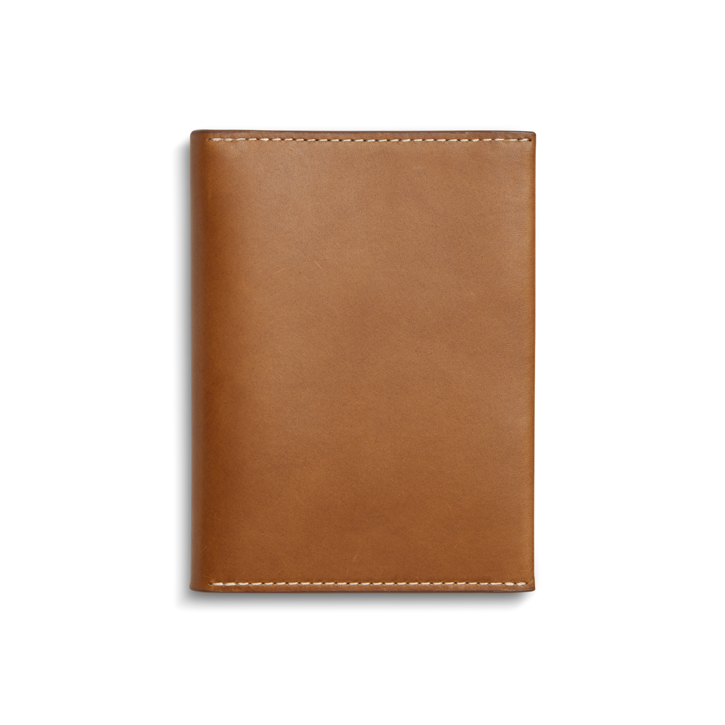 The Shinola Passport Holder - Tan is a rectangular Italian leather travel accessory with white edge stitching, shown closed against a plain white background.