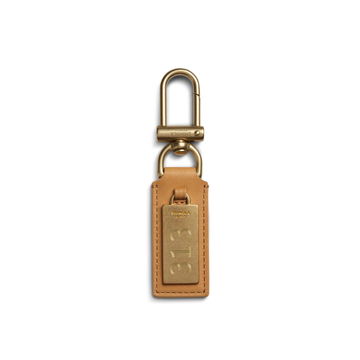 The Shinola Birdy Keychain - Honey features tan leather with a gold-tone metal tag engraved "313" and a gold clip, shown on a white background—an elegant, engravable accessory for everyday use.
