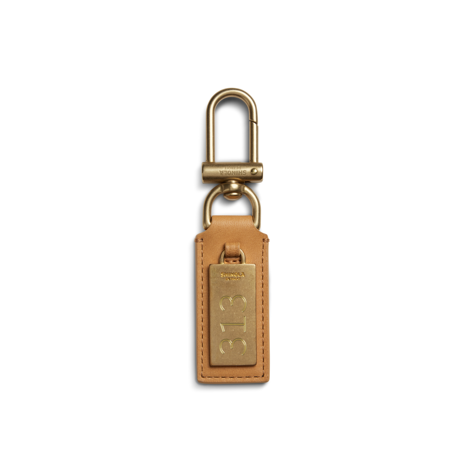 The Shinola Birdy Keychain - Honey features tan leather with a gold-tone metal tag engraved "313" and a gold clip, shown on a white background—an elegant, engravable accessory for everyday use.