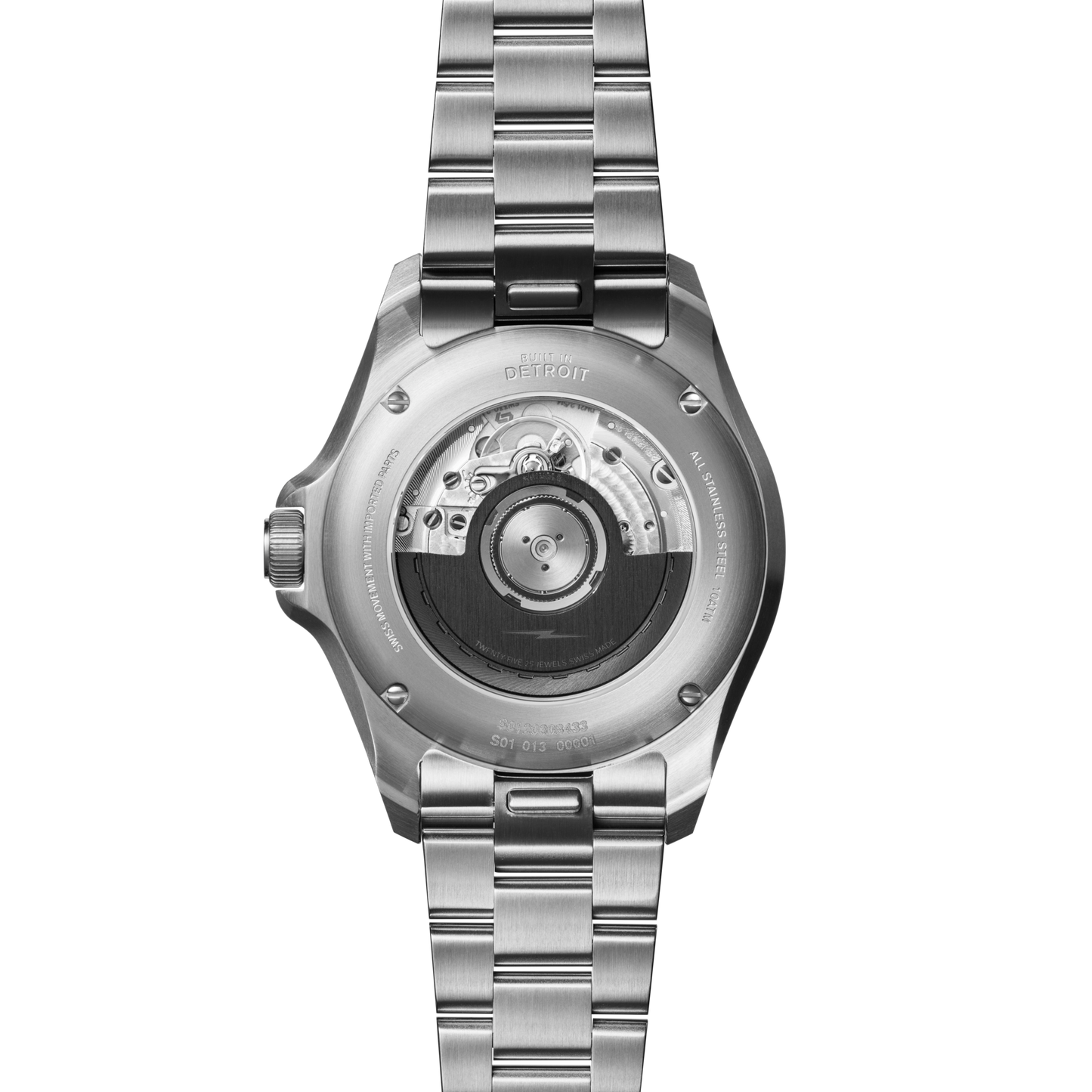 Back view of the Shinola Monster GMT Automatic Watch - Whiskey, showing its exhibition case back with visible automatic movement and engraved text, paired with a metal link bracelet.