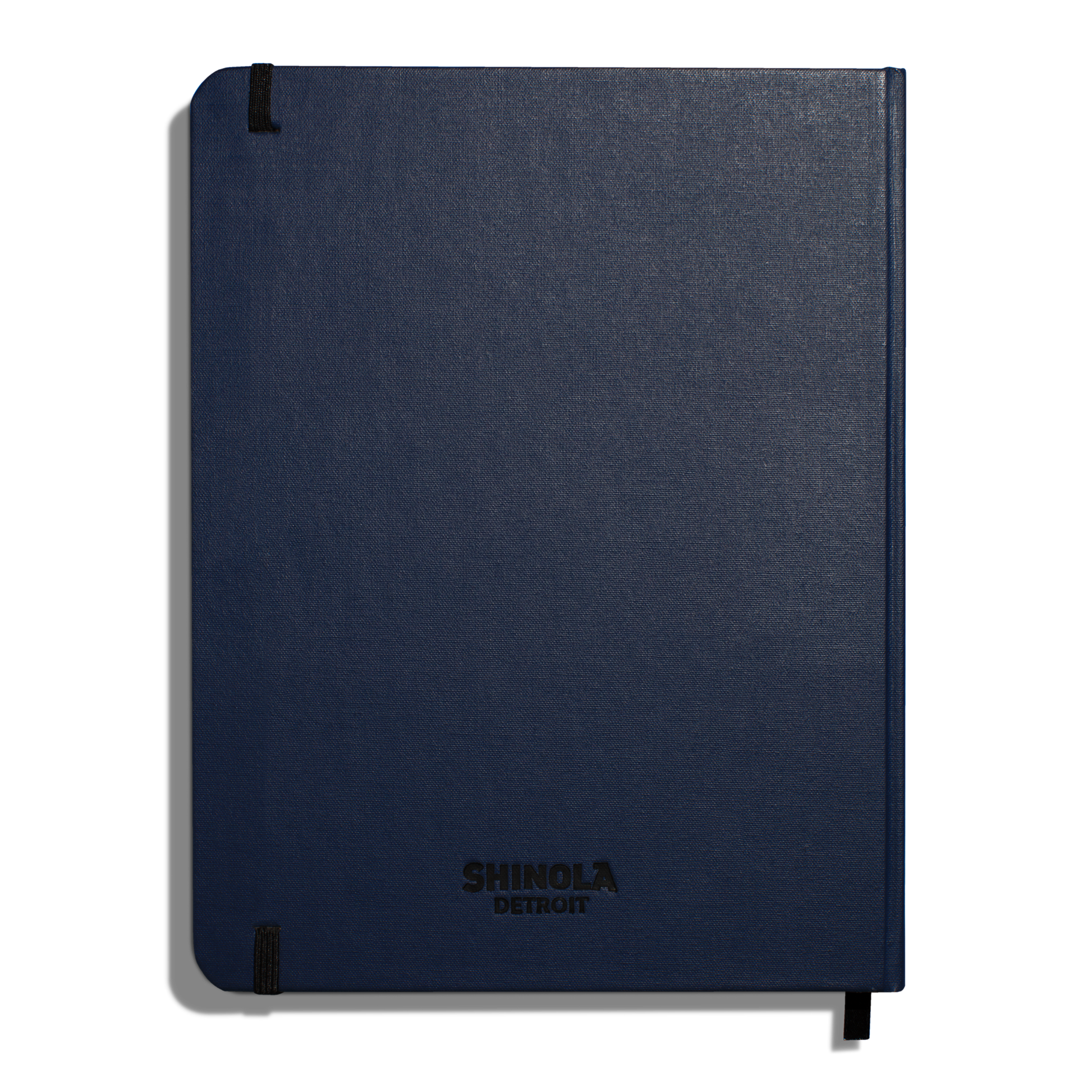 The Shinola Large Hard Ruled Journal in navy features durable linen covers, “Shinola Detroit” printed in black, acid-free paper, and secure black elastic bands for a stylish and long-lasting notebook.