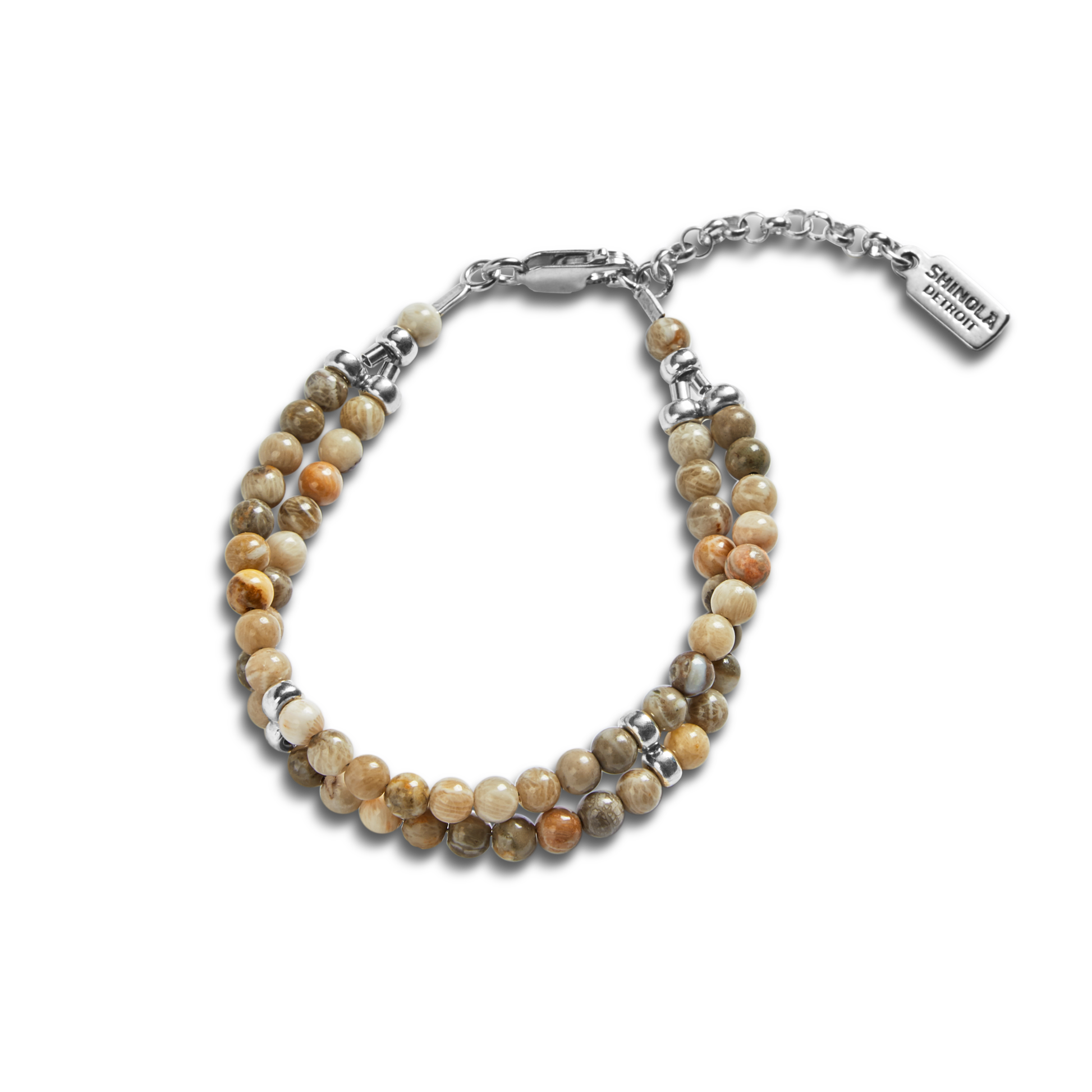 The Double Row Petoskey Beaded Bracelet by Shinola features round, earthy Petoskey stones, silver accents, a sterling silver closure, and a rectangular tag engraved with the Shinola name.
