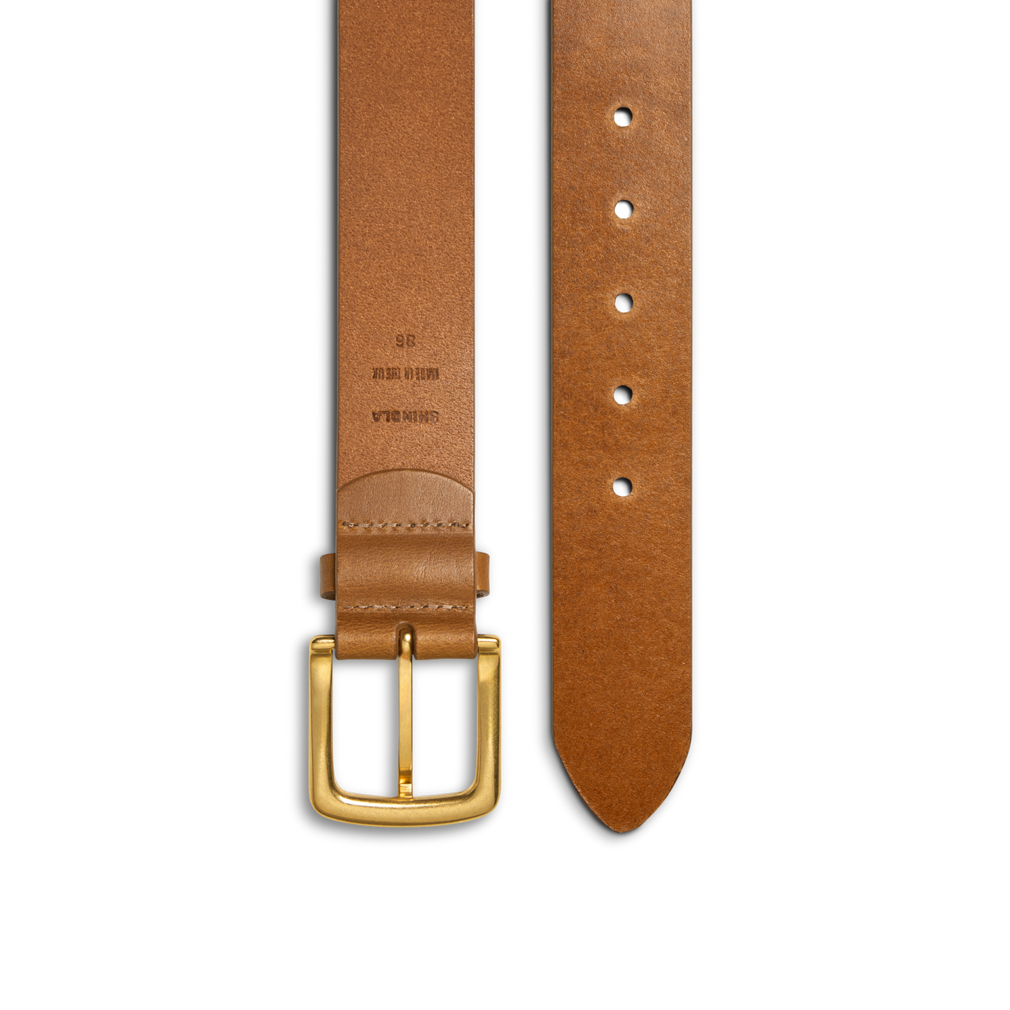 The Shinola 1 1/2" Essential Belt in natural tan leather features a gold rectangular buckle, edge stitching, and multiple fit options. Size and material details are displayed at the buckle end for convenience.
