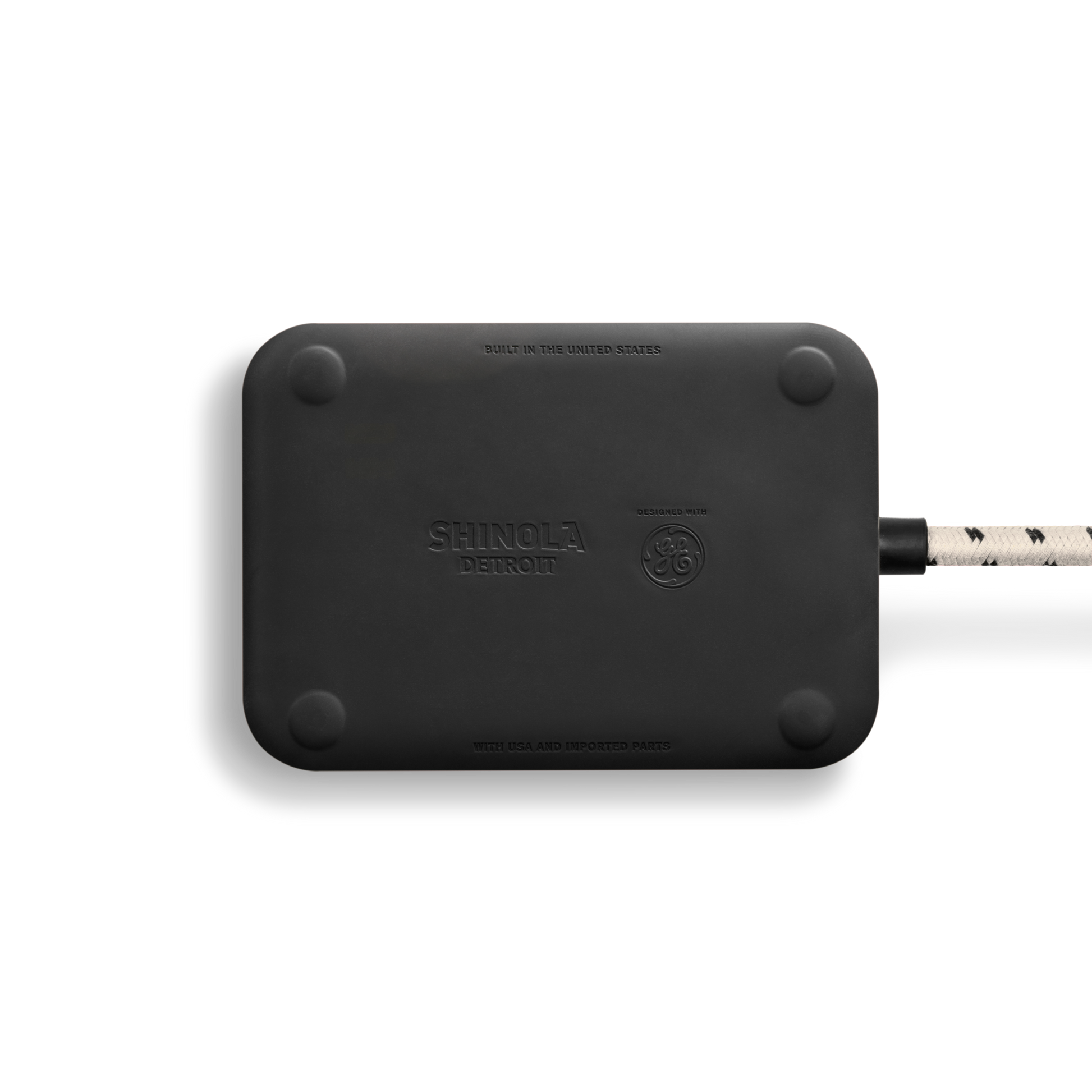 A cream rectangular Shinola 5 Port Power Supply with rounded corners, visible braided power cord for USB A/C charging, and embossed Shinola branding, set against a plain white background.