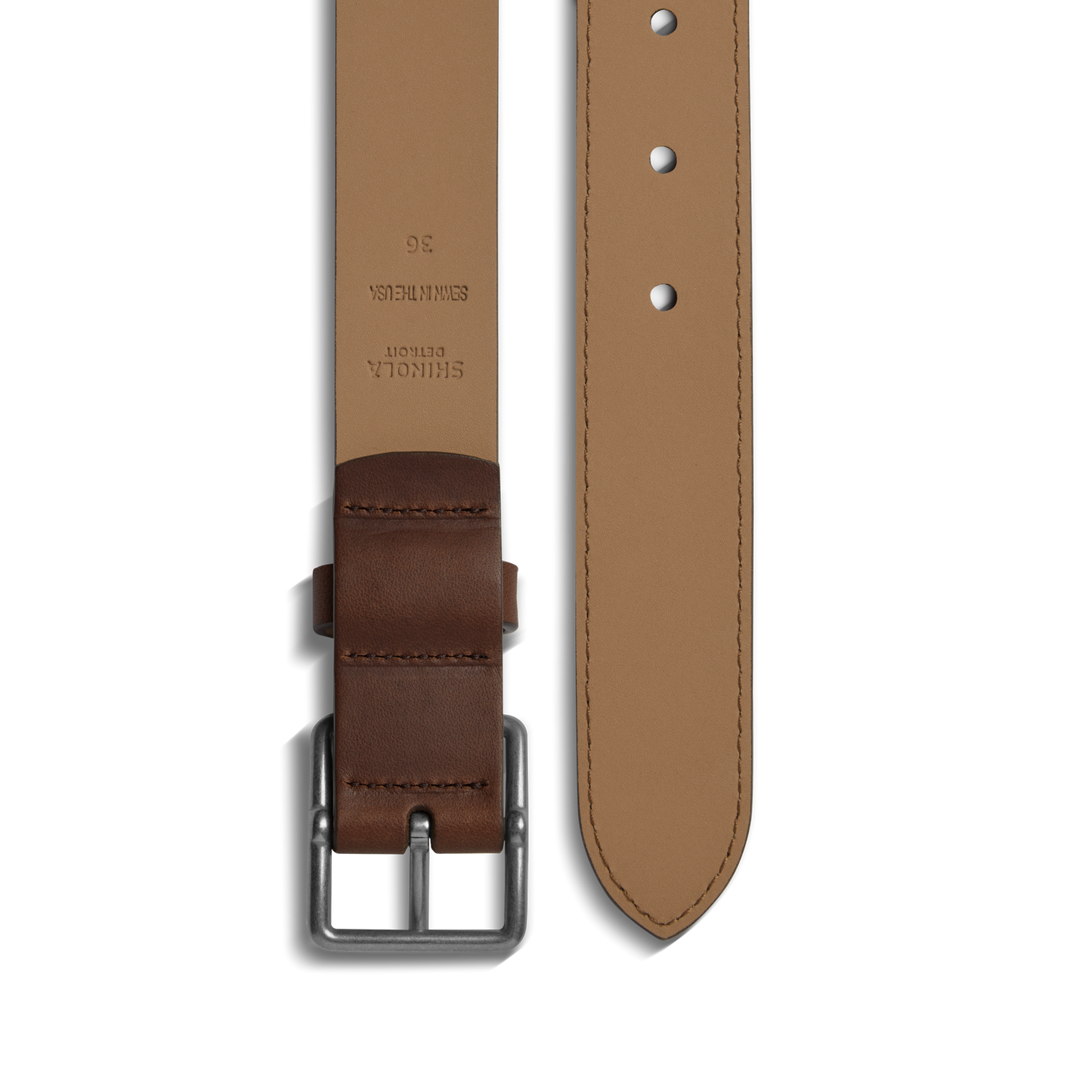 The Shinola 1 1/4" Center Bar Buckle Belt in medium brown features a rectangular silver buckle, multiple holes, and embossed branding near the buckle, shown here laid flat.