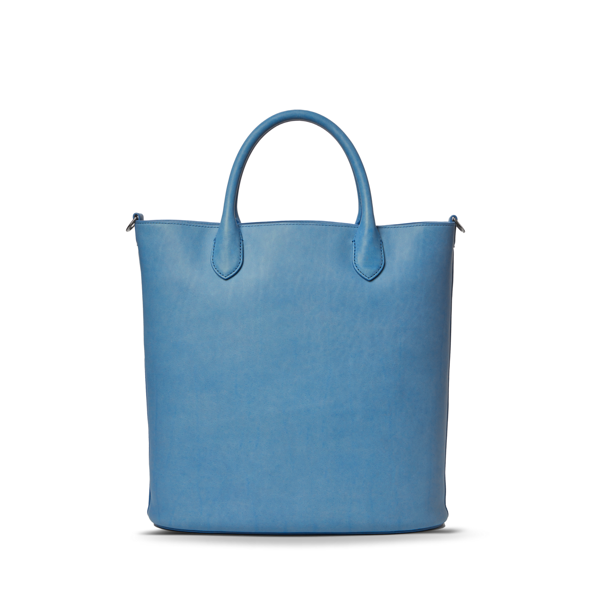The Shinola 12 Hour Tote Bag - River is a minimalist, light blue natural leather tote with two short handles, ideal for everyday use and shown against a plain white background.
