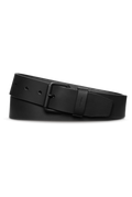 The Shinola 1 1/2" Rambler Belt - Black, crafted from bridle leather with a matte black buckle, is shown coiled on a white background—a timeless addition to any wardrobe.