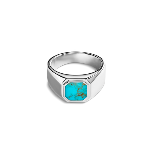 The Shinola Octagonal Inlay Signet Ring Turquoise features a wide sterling silver band with a large octagonal turquoise inlay, highlighted by natural brown veining and set against a plain white background.