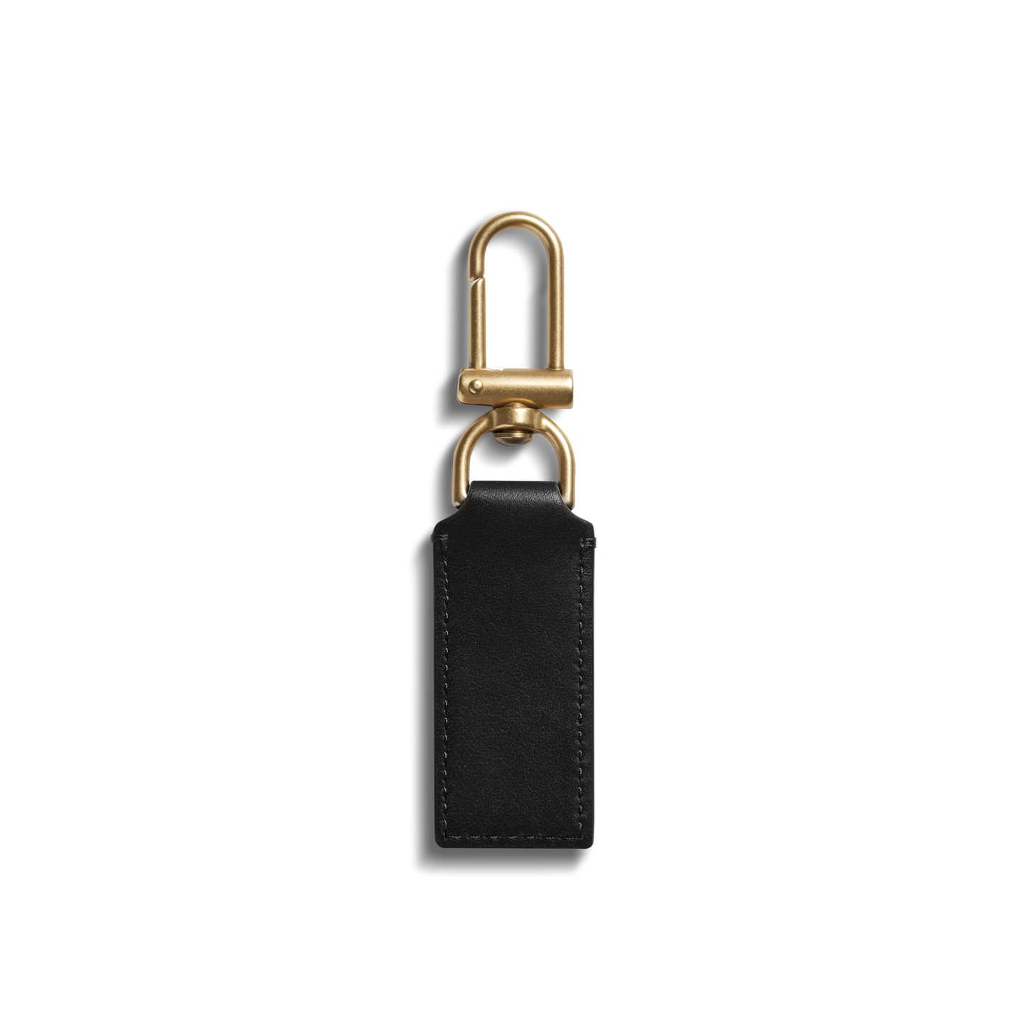 The Shinola Birdy Keychain - Black features a gold metal chain and a rectangular black natural leather fob, displayed on a plain white background.