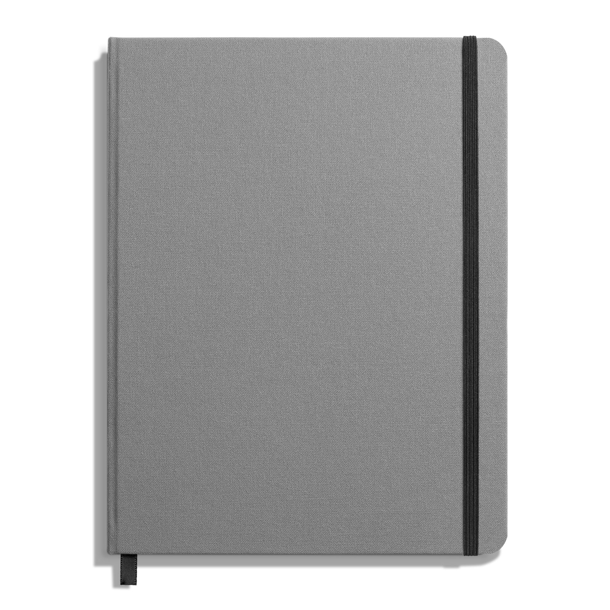 The Shinola Large Hard Plain Journal - Stone is a closed gray hardcover notebook with a black elastic band on the right, smyth-sewn binding, and a black ribbon bookmark visible at the bottom.