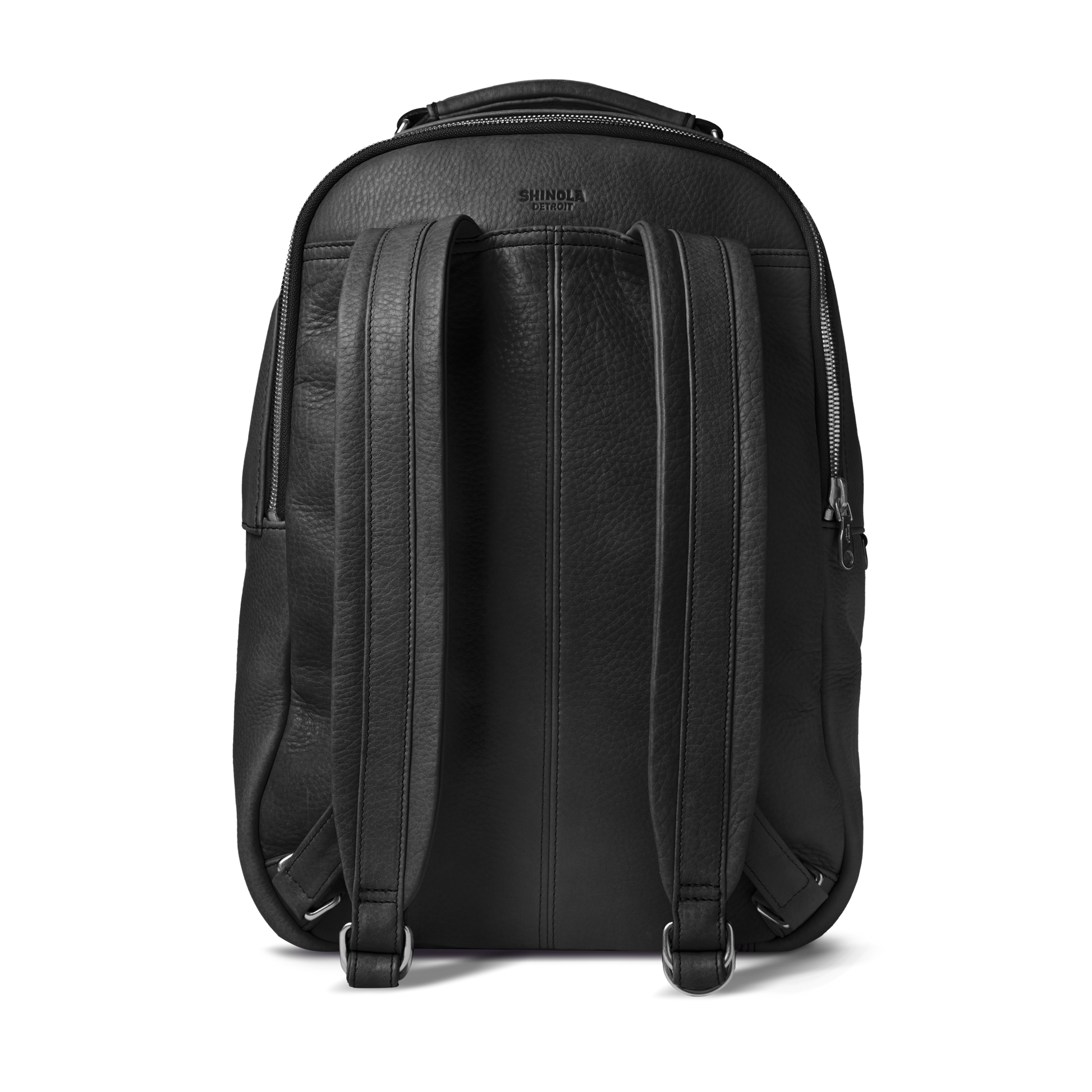The Shinola Runwell Backpack in black premium leather is shown from the back, featuring two padded shoulder straps, a top handle, a visible right-side zipper, and an embossed Shinola logo near the top.