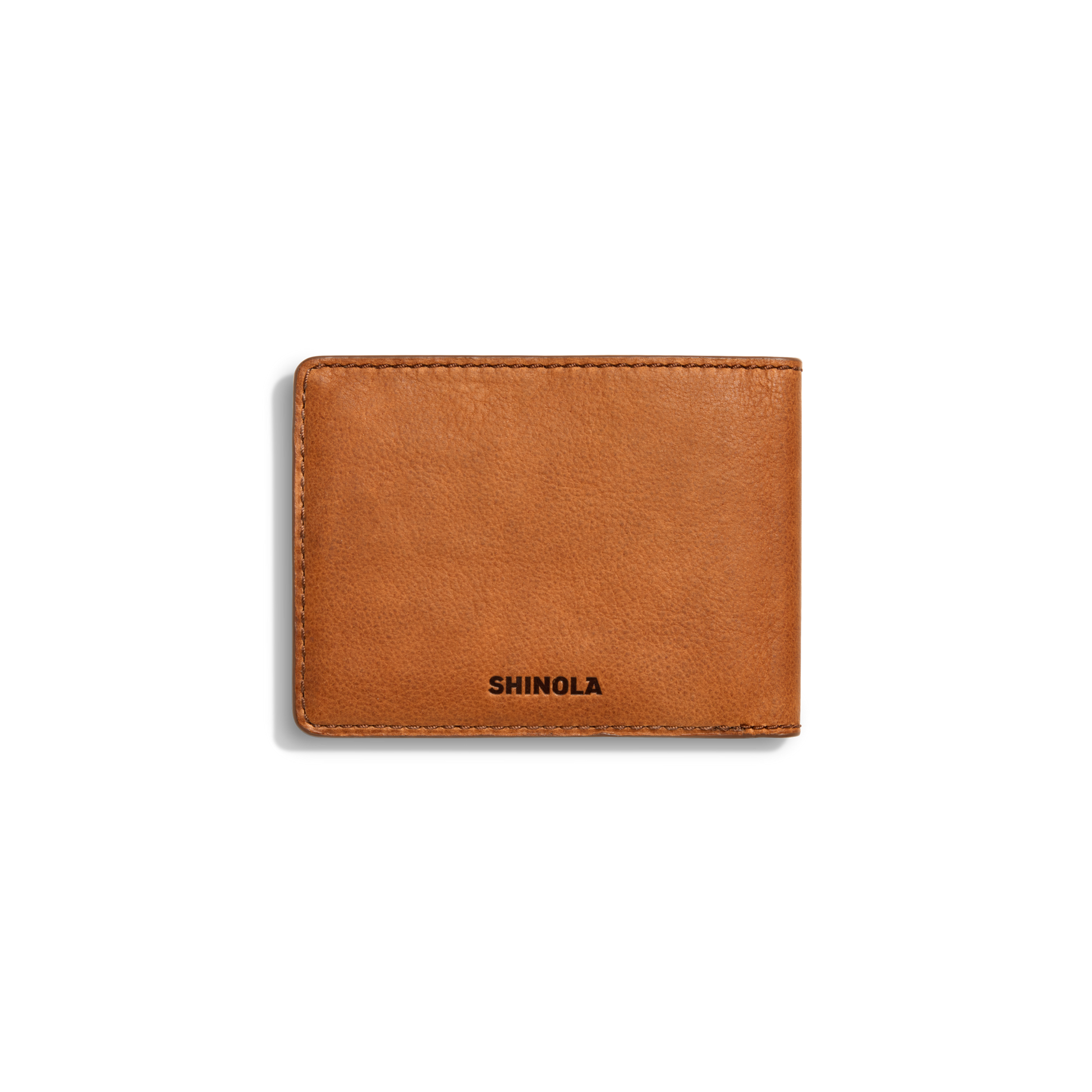 The Slim Bifold Wallet - Tan by Shinola features visible stitching and the brand name embossed in black on premium tan leather, shown on a plain white background.