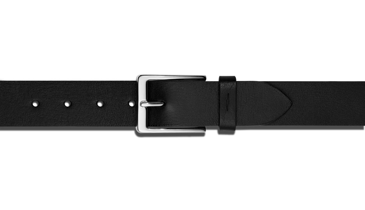 A close-up of the Shinola Lightning Bolt Keeper Belt in black leather with silver-tone hardware and a rectangular buckle, displayed horizontally on a plain white background.