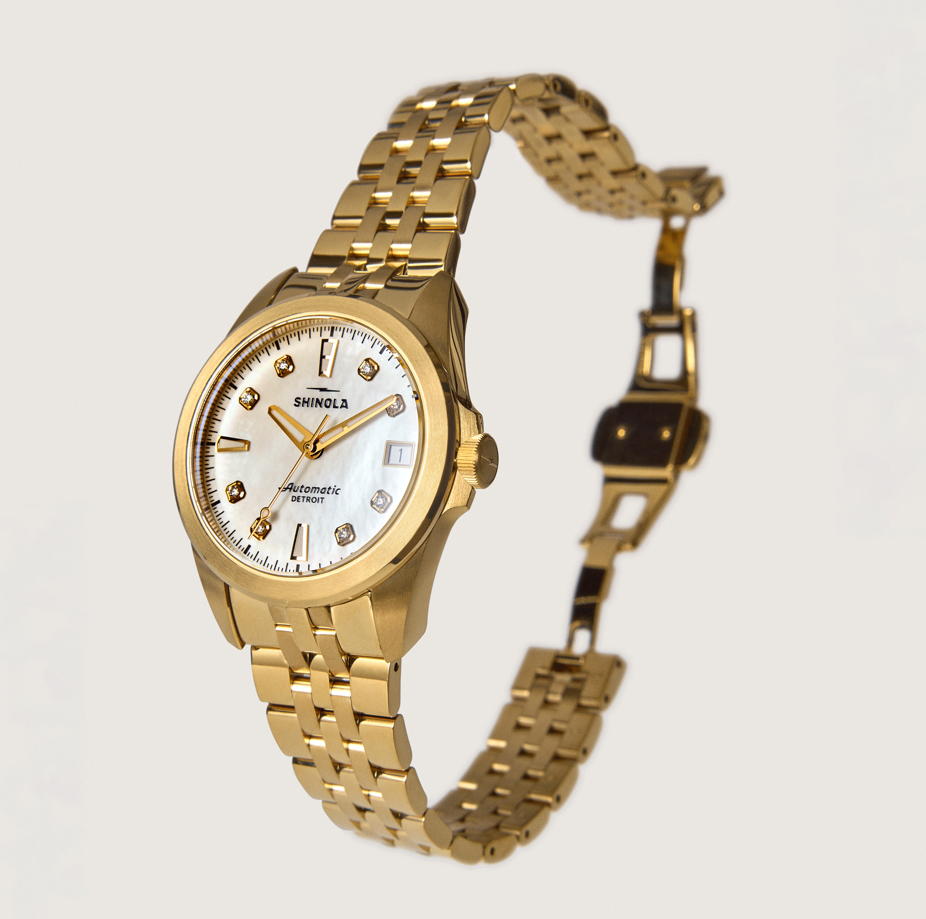 The Shinola Circadian Monster Automatic Watch – Mother of Pearl Diamond features a gold linked bracelet, white mother of pearl dial with diamond indices, and automatic movement, set against a plain light background.
