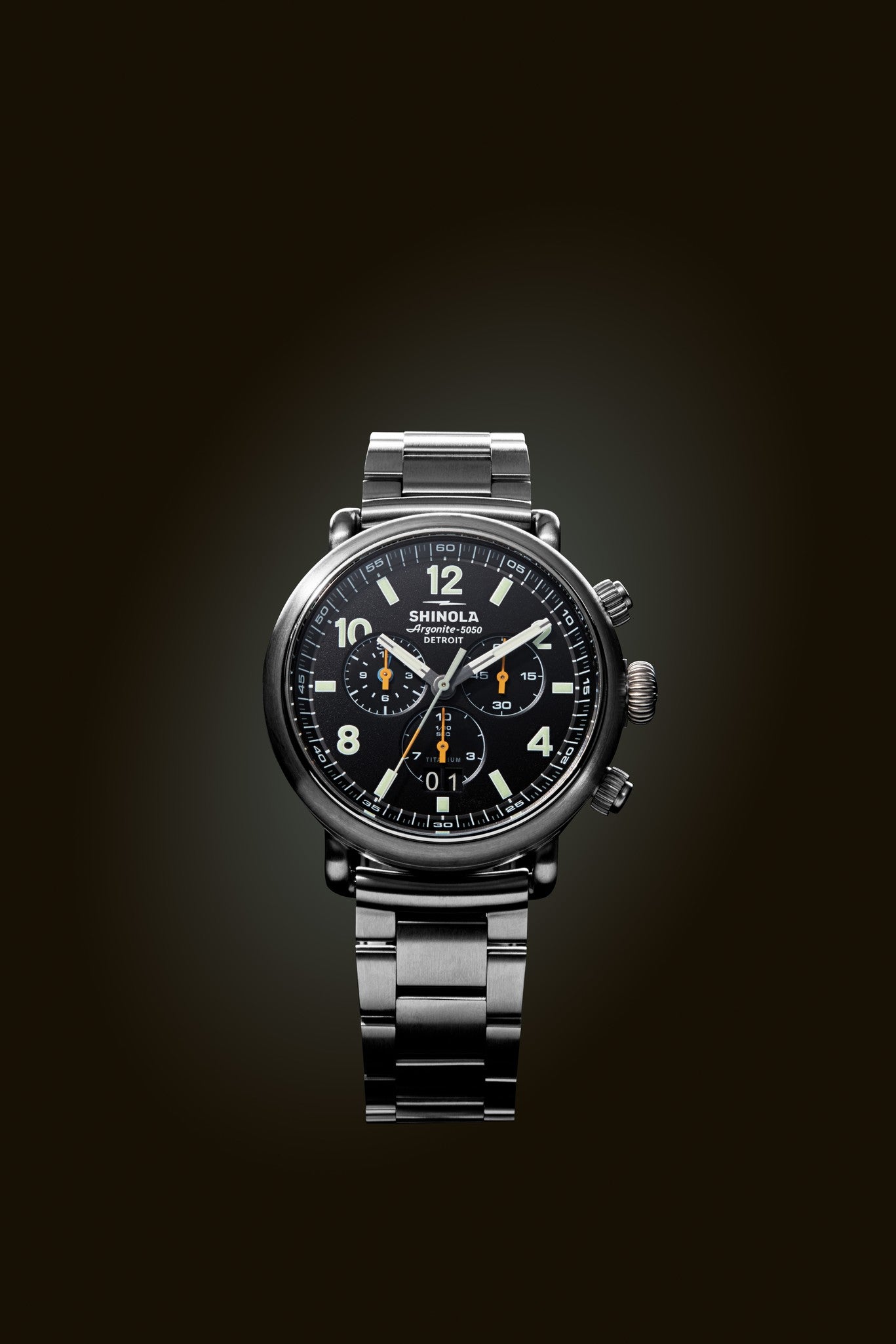 Close-up studio shot of the Shinola Runwell Chronograph West Wind Watch Gift Set with Additional Strap—Black, featuring a black dial and stainless steel bracelet.