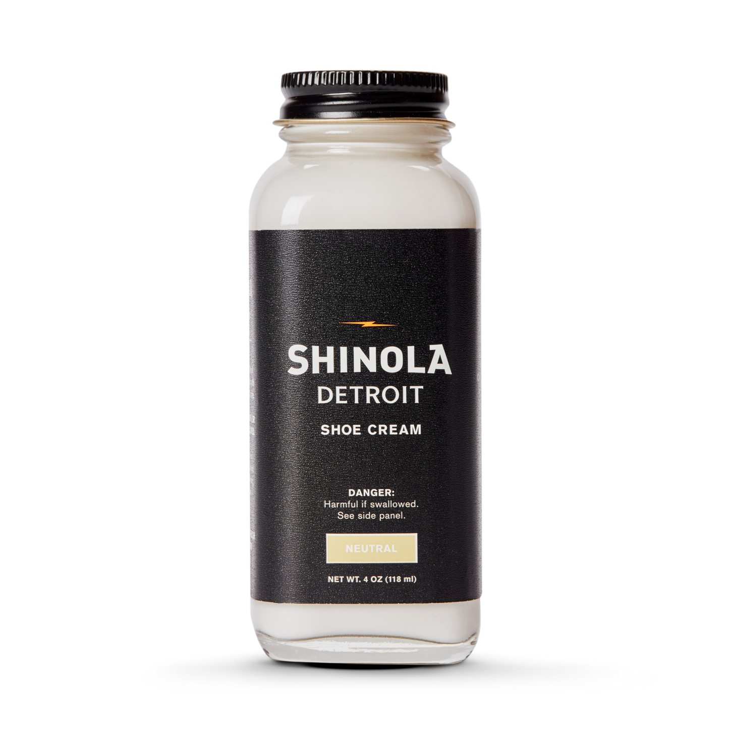 A clear glass jar of Shinola Shoe Cream - Neutral with a black lid and label featuring white and gold text, warning it is harmful if swallowed.