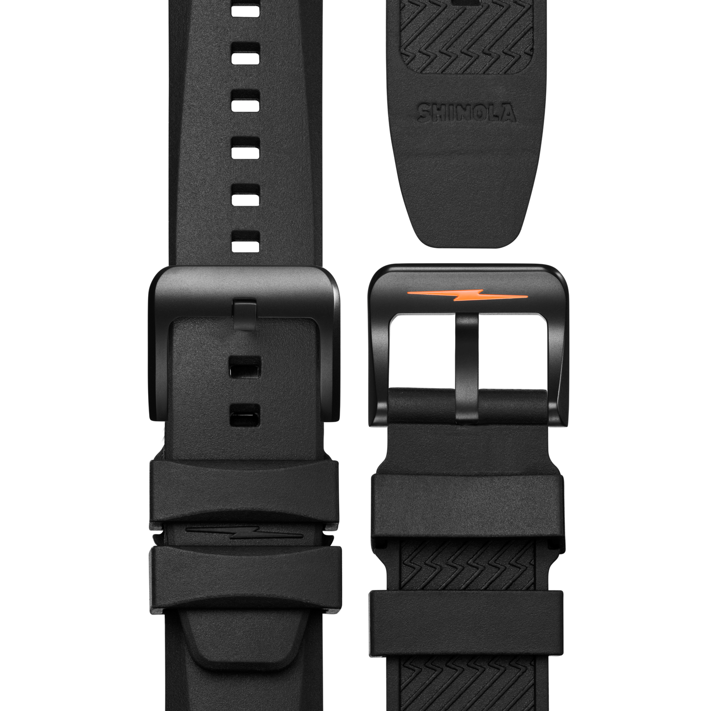Close-up of a black rubber strap with matte black buckle and orange lightning bolt, designed for the Shinola Forged Carbon Monster Watch. Features multiple adjustment holes and an embossed Shinola logo on the underside.
