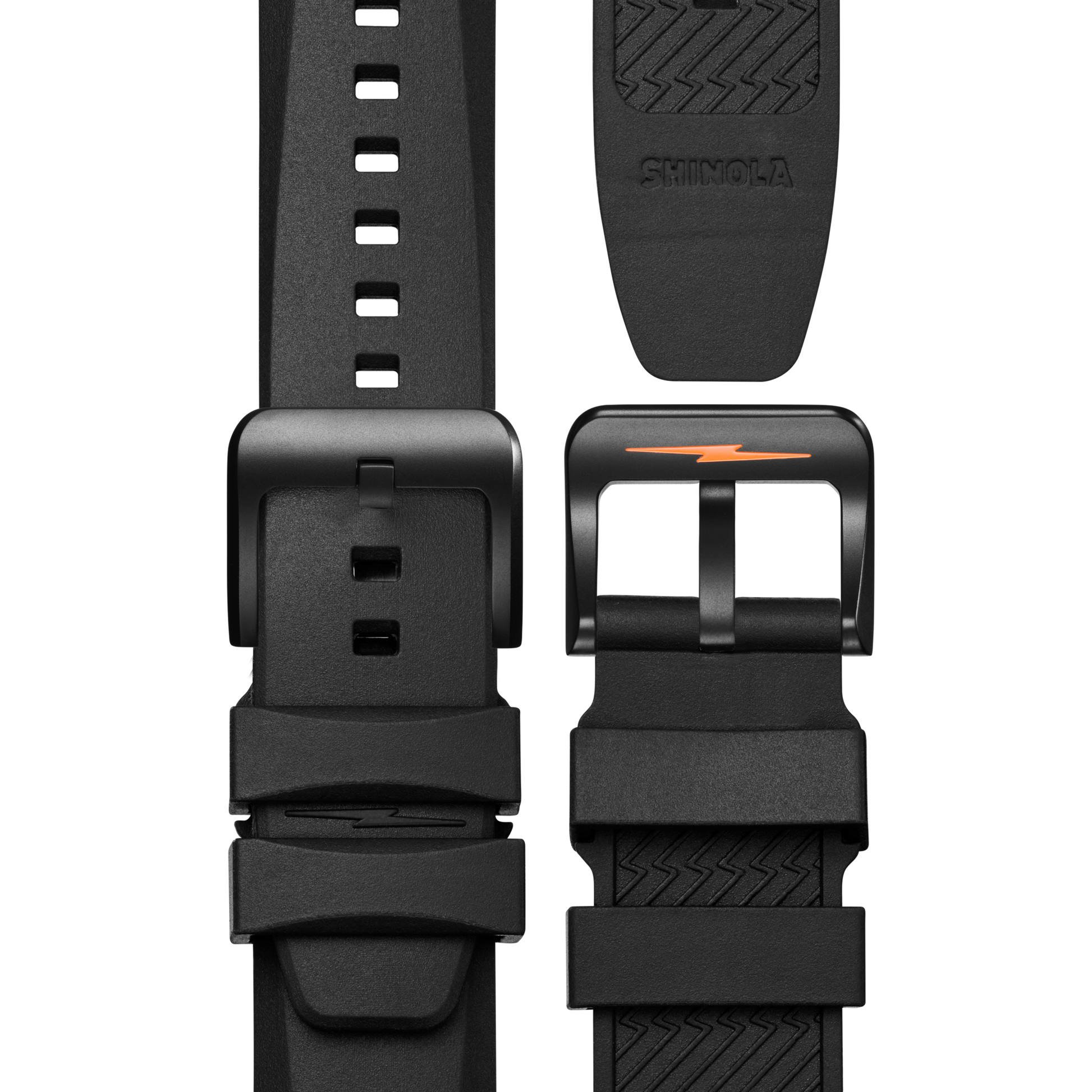 Close-up of a black rubber strap with matte black buckle and orange lightning bolt, designed for the Shinola Forged Carbon Monster Watch. Features multiple adjustment holes and an embossed Shinola logo on the underside.