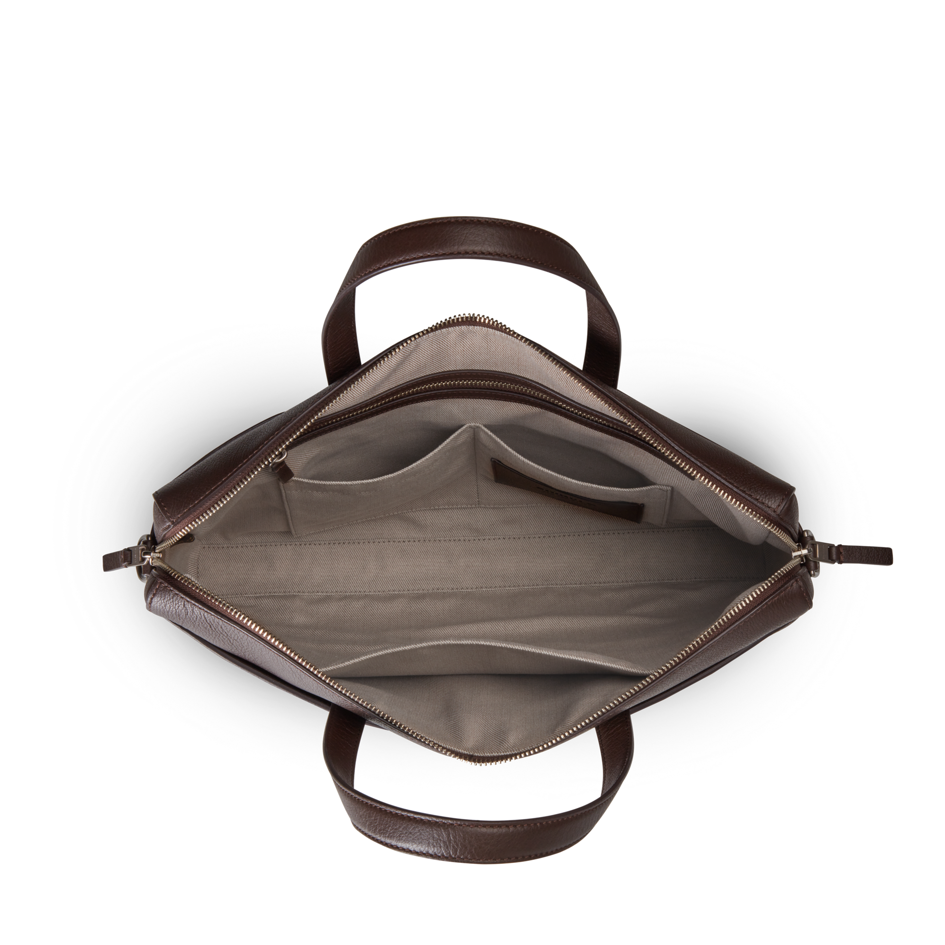 Top-down view of an open Shinola Canfield Briefcase - Espresso in brown pebbled leather with beige fabric lining, featuring a laptop pocket, two main compartments, interior pockets, and sturdy handles. The bag is empty and neatly organized.