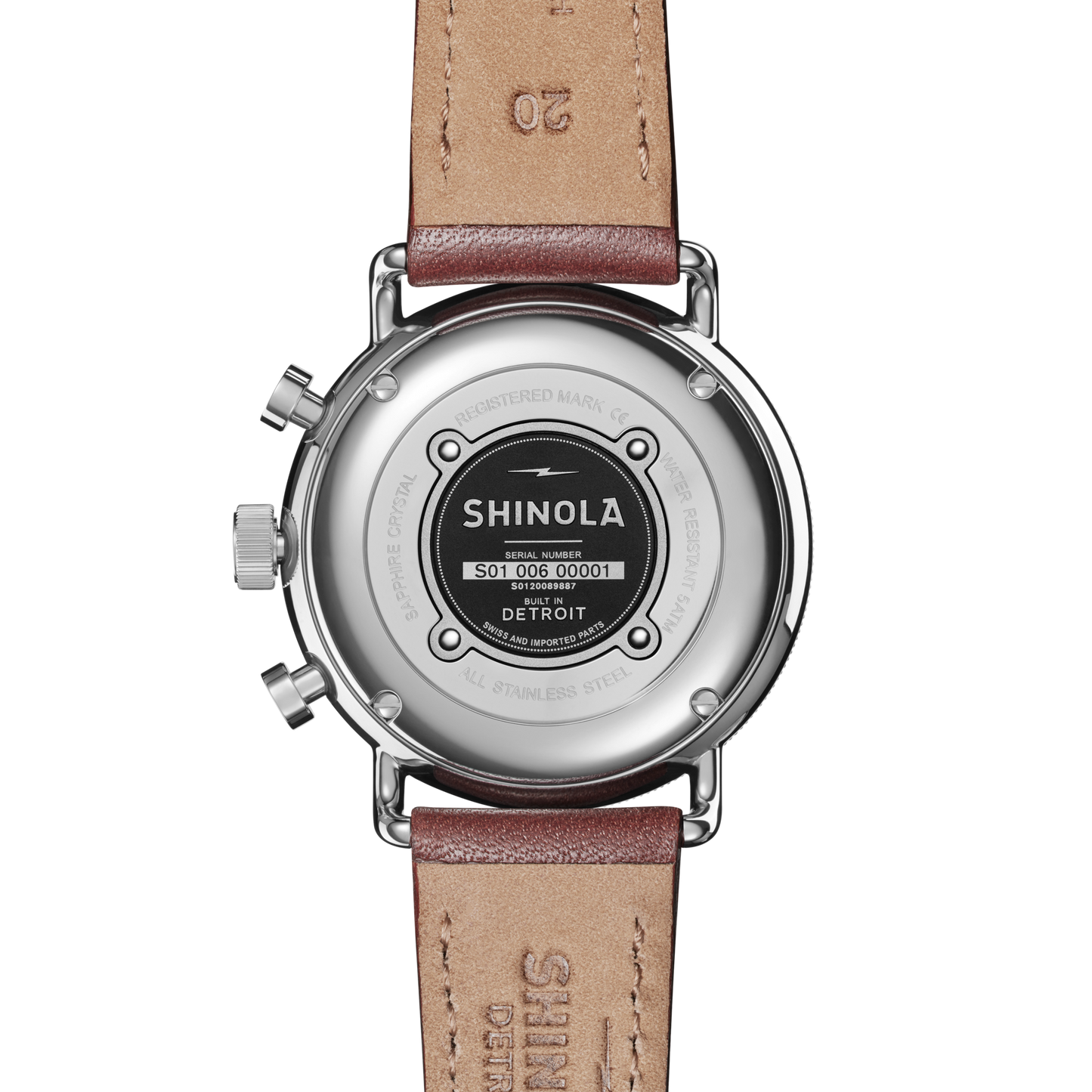 The back of a Shinola Canfield Sport Chronograph Watch - Midnight Blue with a leather strap and stainless steel case, featuring an engraved serial number “501.006.00001” and the text “Built in Detroit.”.