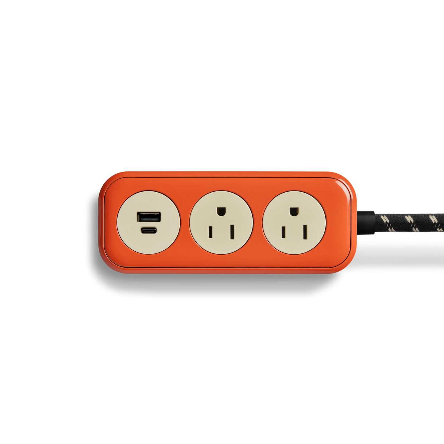 The Shinola 2 Port Power Supply - Tangerine is a red rectangular power strip featuring two electrical outlets, fast-charging USB-A and USB-C ports, and a durable braided cord, shown on a white background.