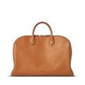 The Shinola Bixby Work Satchel - Tan is a sleek, minimalist natural leather laptop bag with two handles, zipper closure, and subtle Shinola embossing near the bottom center, shown against a plain white background.
