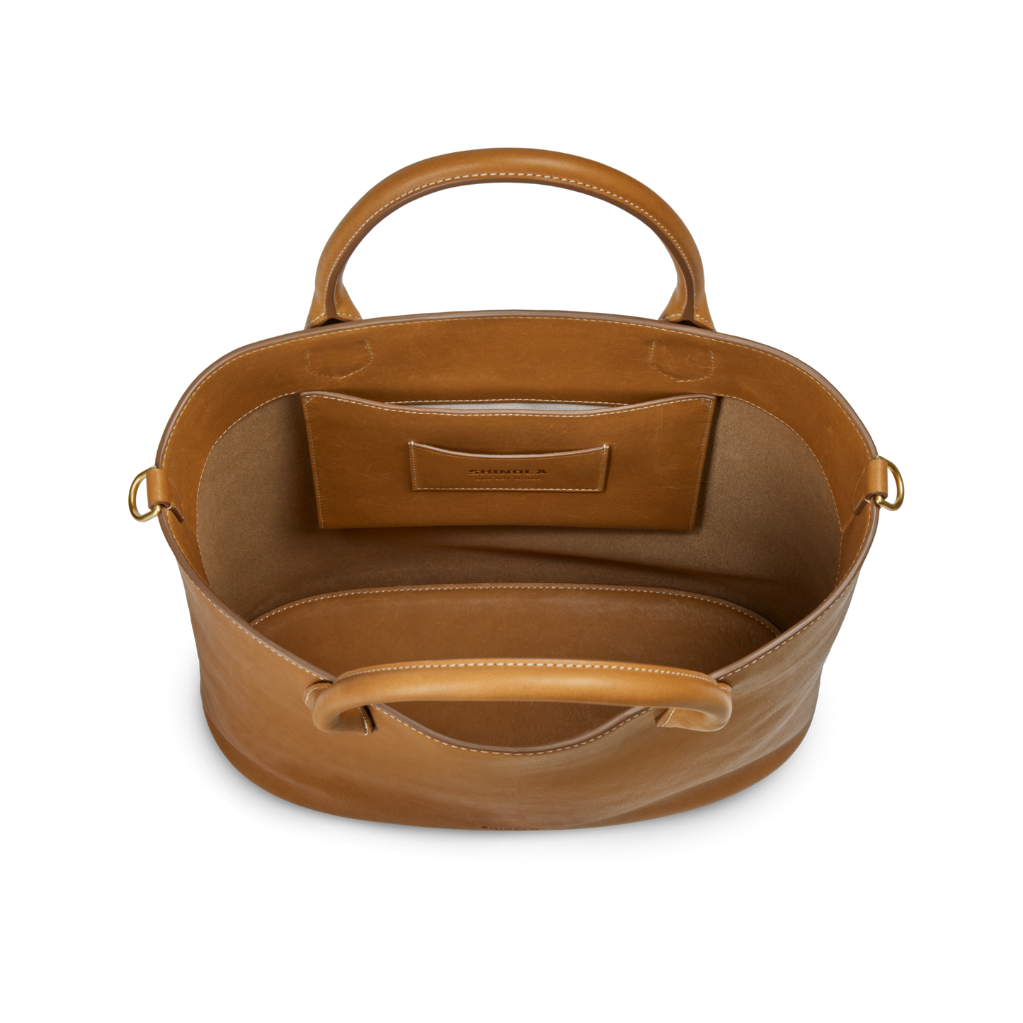 Top view of the Shinola 12 Hour Tote Bag in tan leather with two handles, an unlined interior, and a small pocket with subtle embossed branding—ideal for carrying daily essentials.