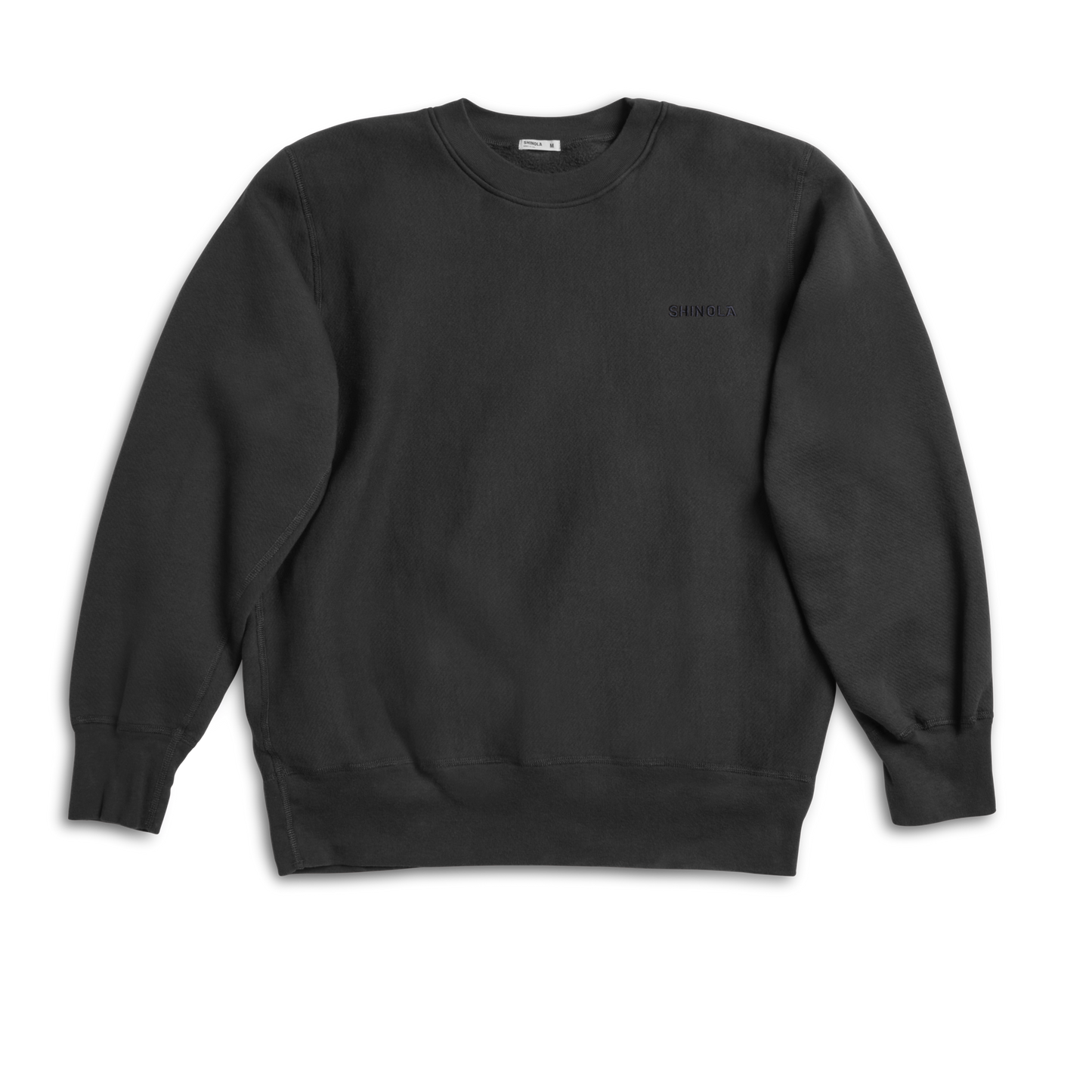 The Shinola Fleece Logo Sweatshirt in Vintage Black features a unisex classic fit, soft American cotton fleece, ribbed cuffs and hem, and displays the logo on a plain black long-sleeve crewneck against a white background.