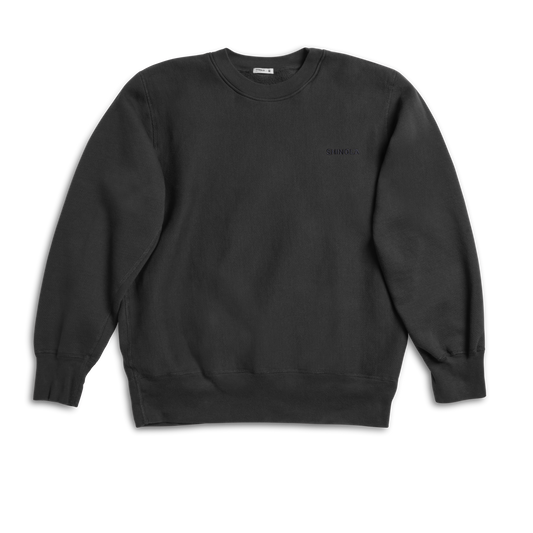 The Shinola Fleece Logo Sweatshirt in Vintage Black features a unisex classic fit, soft American cotton fleece, ribbed cuffs and hem, and displays the logo on a plain black long-sleeve crewneck against a white background.