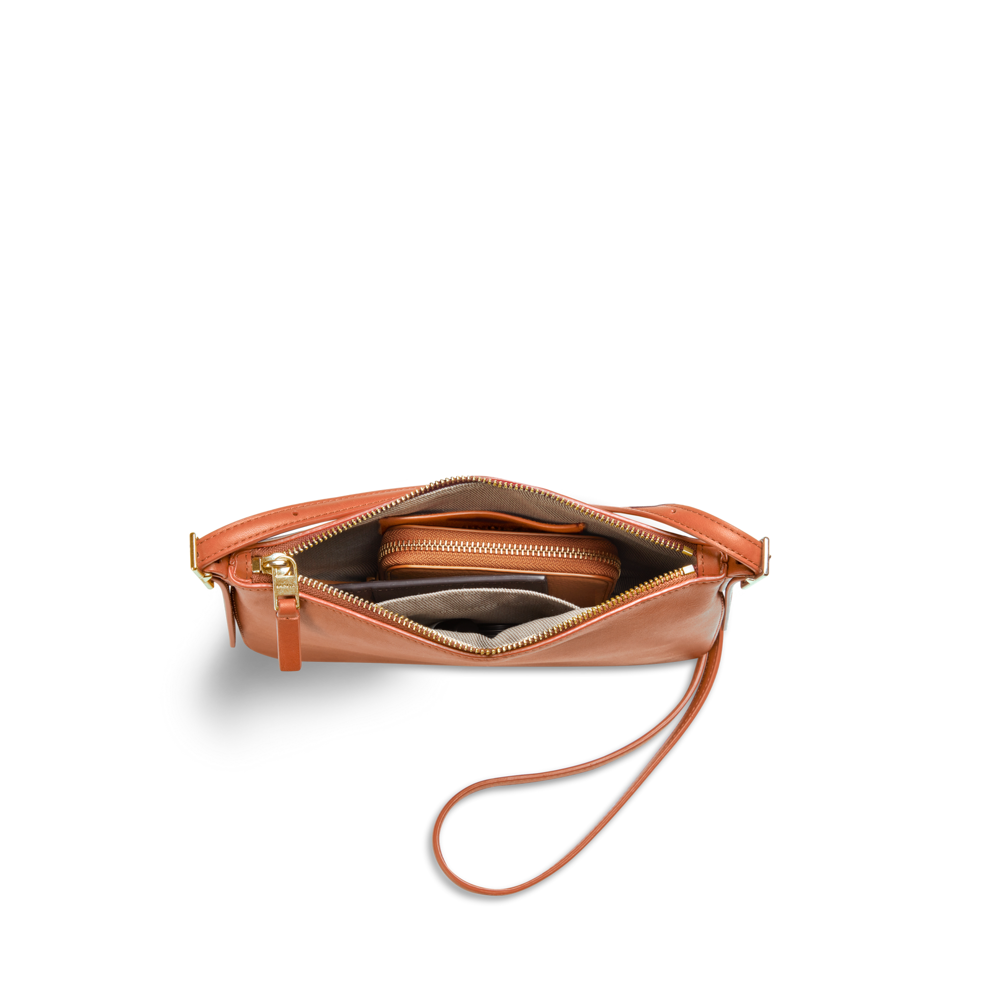 The Shinola Small Bixby Crossbody in Rust is shown from above with its zipper open, revealing a wallet and other items inside against a white background—an ideal everyday accessory.