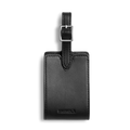The Shinola Luggage Tag - Black, made from Italian Vachetta leather with a silver buckle and embossed branding, is shown on a white background. Personal monogramming is available.