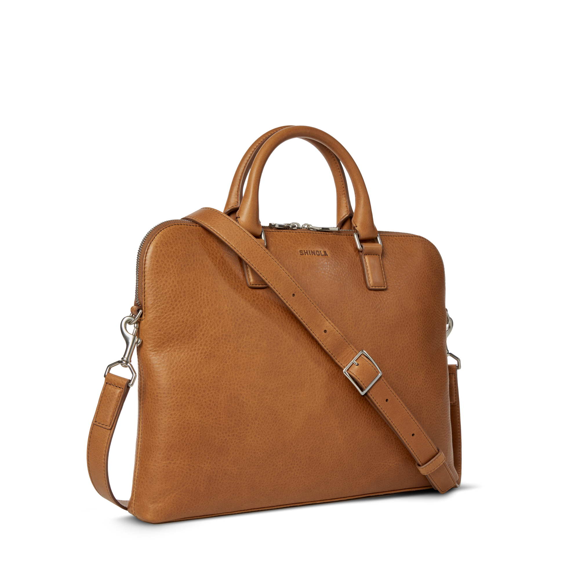 The Shinola Portfolio Briefcase - Tan, crafted from European leather with dual handles, a detachable shoulder strap, and silver hardware, is displayed on a plain white background.
