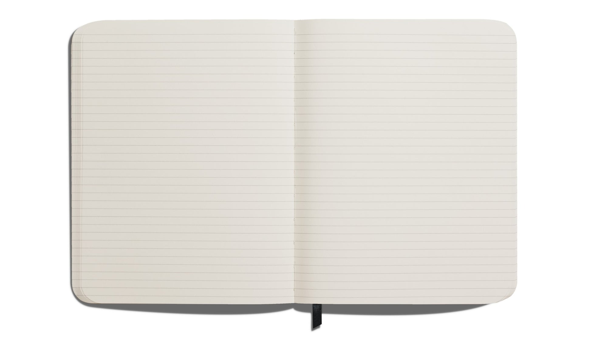 The Shinola Large Hard Ruled Journal in Navy, featuring acid-free lined pages and a black ribbon bookmark, lies flat on a white surface. Its elegant hard linen cover adds a sophisticated touch.