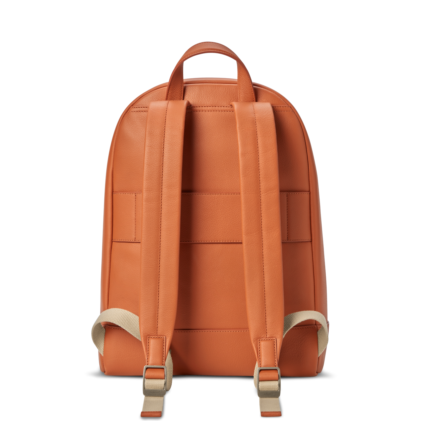 The Shinola Canfield Backpack in rust features adjustable beige straps and a top handle, shown from the back against a white background.