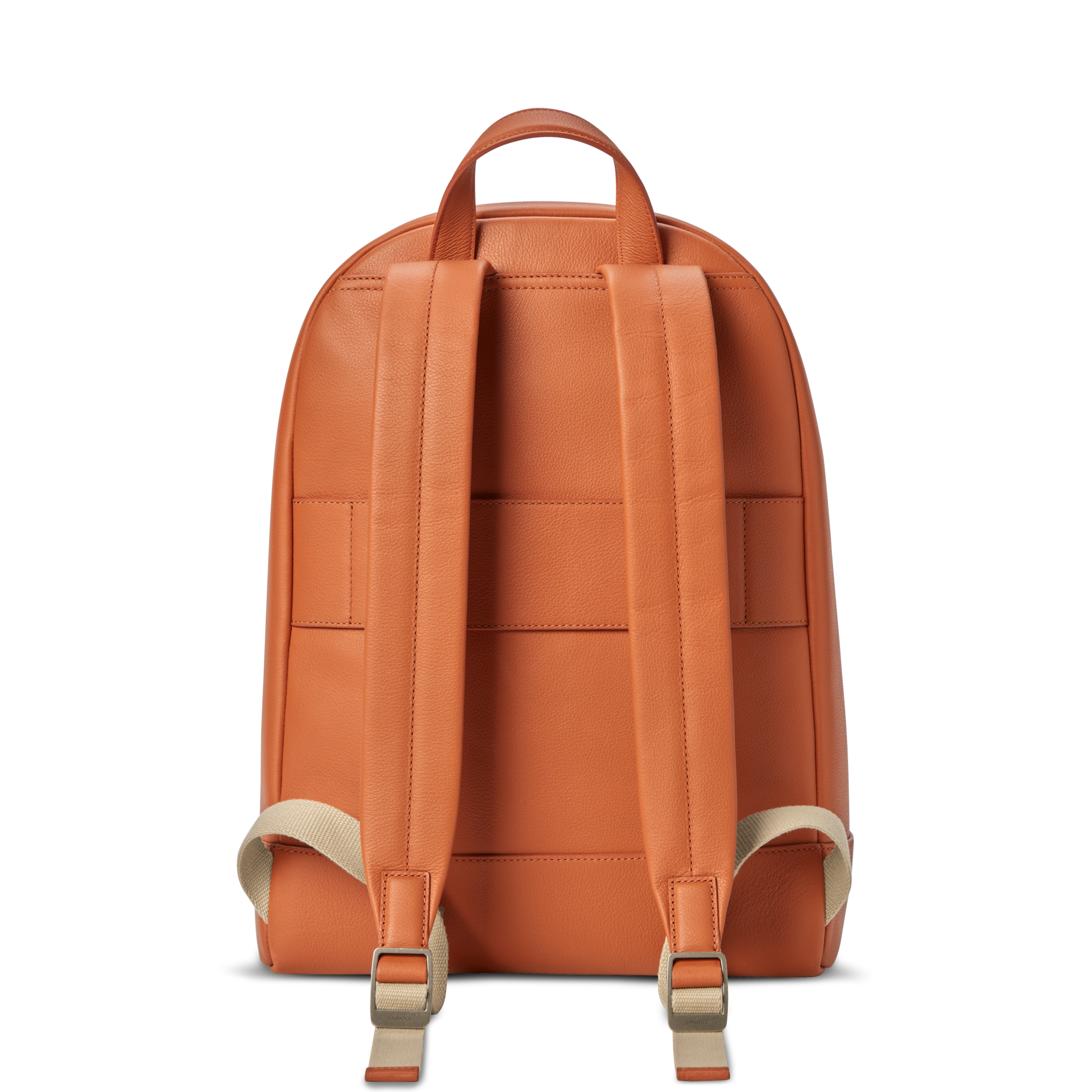 The Shinola Canfield Backpack in rust features adjustable beige straps and a top handle, shown from the back against a white background.