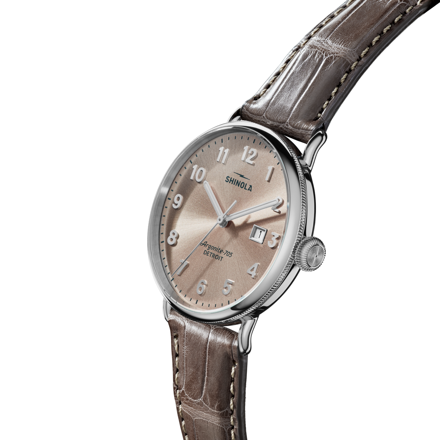 The Shinola Canfield Watch features a 38mm case, light brown dial with silver hour markers and date window, and a brown American alligator leather strap with white stitching, shown on a plain white background.