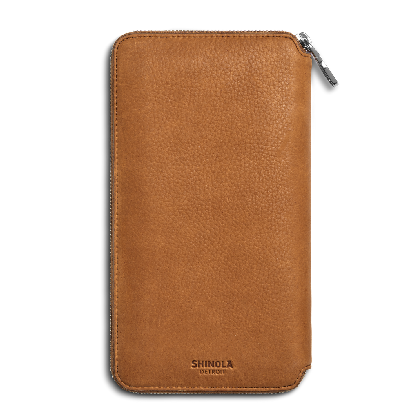 The Shinola Organizer Wallet - Tan features natural grain leather with a pebbled texture, a zip closure, and the SHINOLA DETROIT logo embossed at the bottom—ideal as a stylish travel organizer or passport holder.