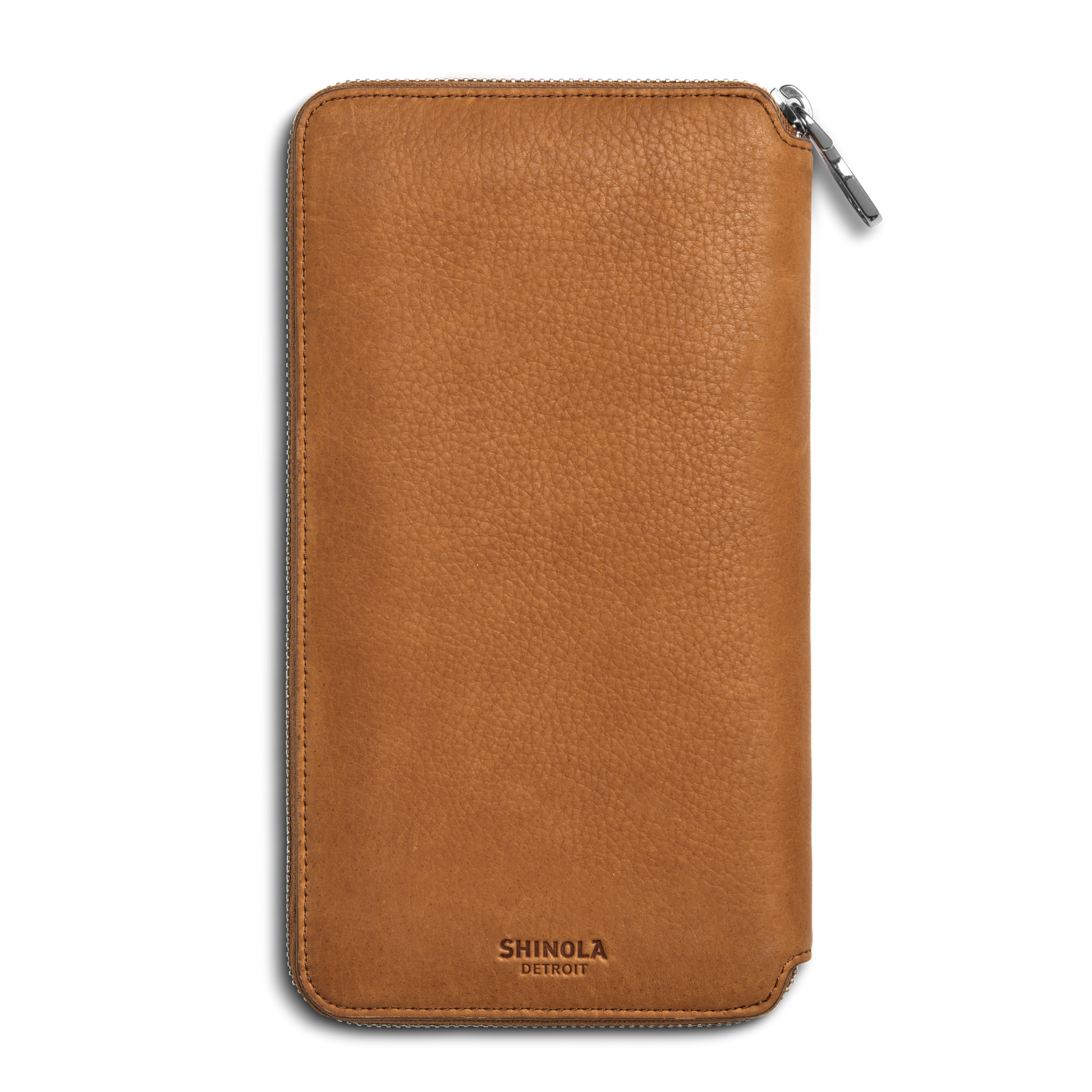 The Shinola Organizer Wallet - Tan features natural grain leather with a pebbled texture, a zip closure, and the SHINOLA DETROIT logo embossed at the bottom—ideal as a stylish travel organizer or passport holder.
