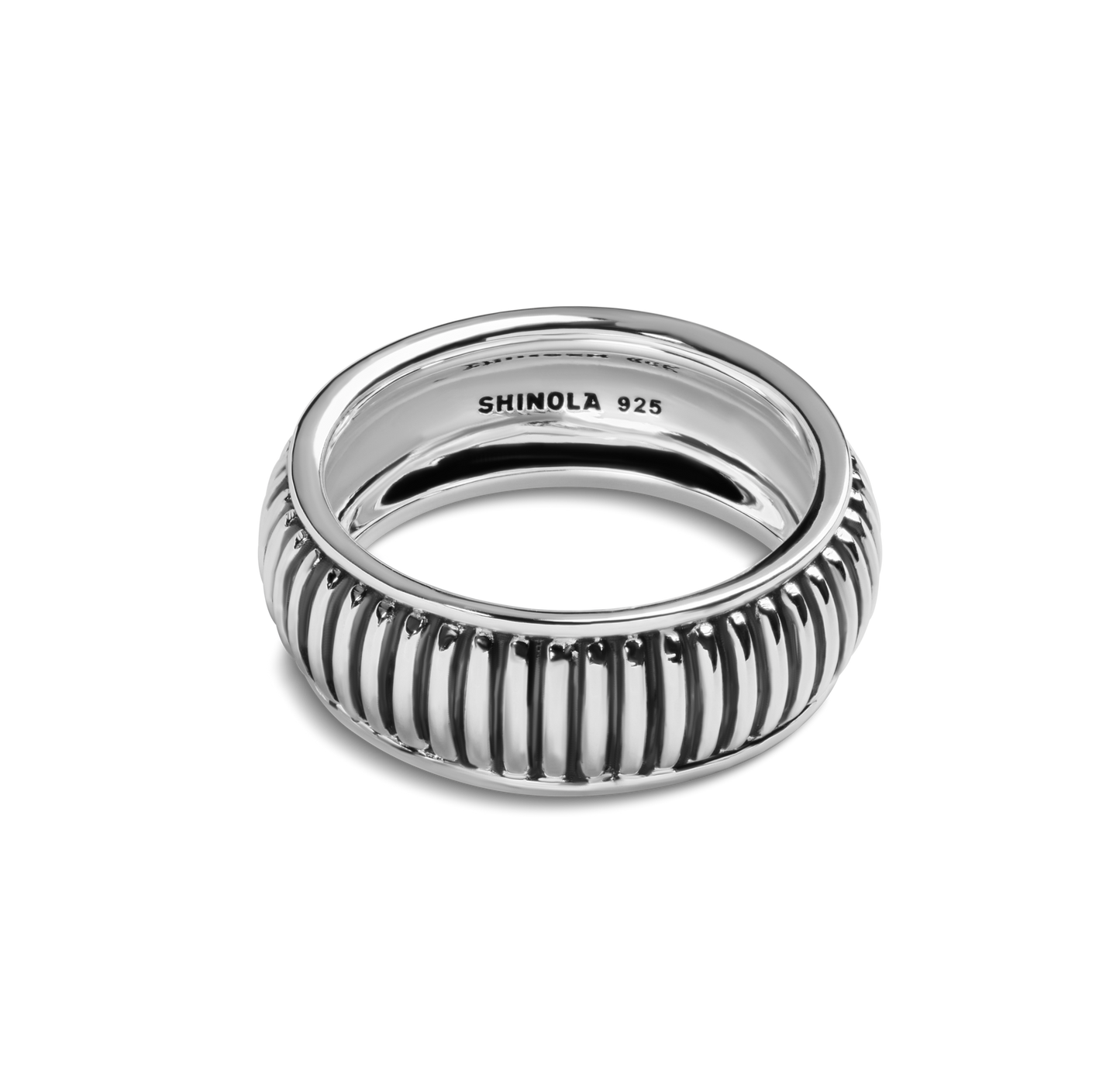 The Coin Edge Band 10MM by Shinola is a sterling silver ring with vertical ridges for a coin edge look and "SHINOLA 925" engraved inside, shown on a white background. A versatile statement piece for any collection.