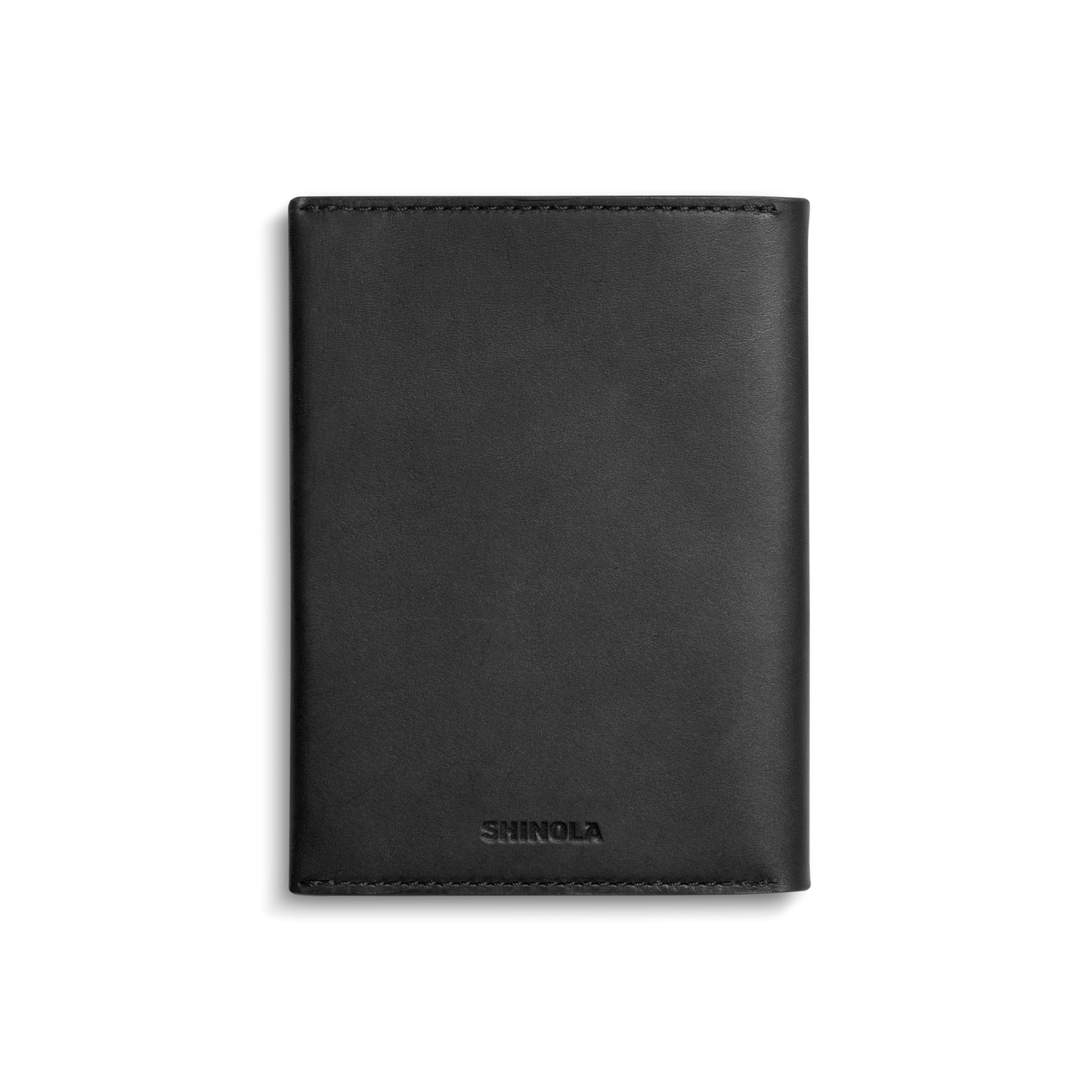 A black Shinola Passport Holder made from Italian Vachetta leather, featuring the brand name embossed at the bottom and photographed on a plain white background—an elegant accessory for travel or everyday use.