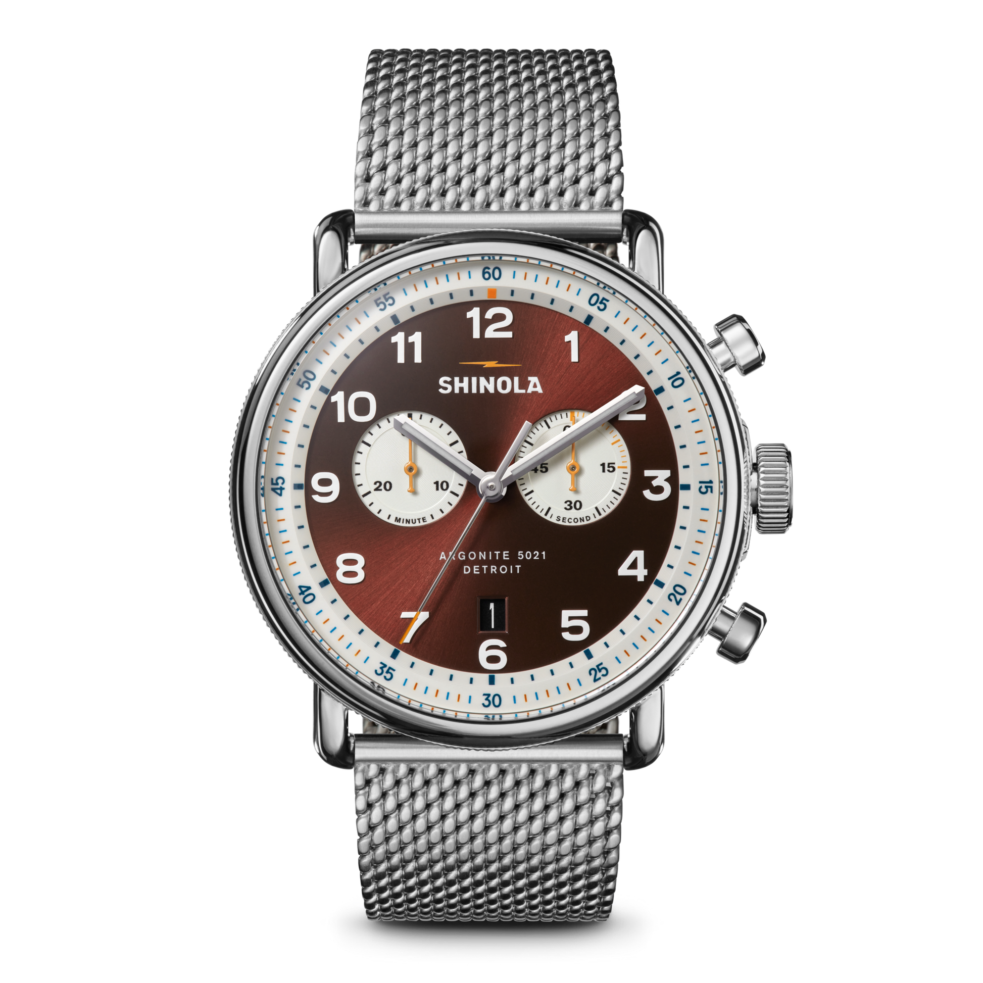 The Shinola Canfield C56 Chronograph Watch - Whiskey features a silver stainless steel mesh bracelet, brown dial with white subdials, silver hour markers, blue and orange accents, and two side pushers for a sleek mid-century modern look.