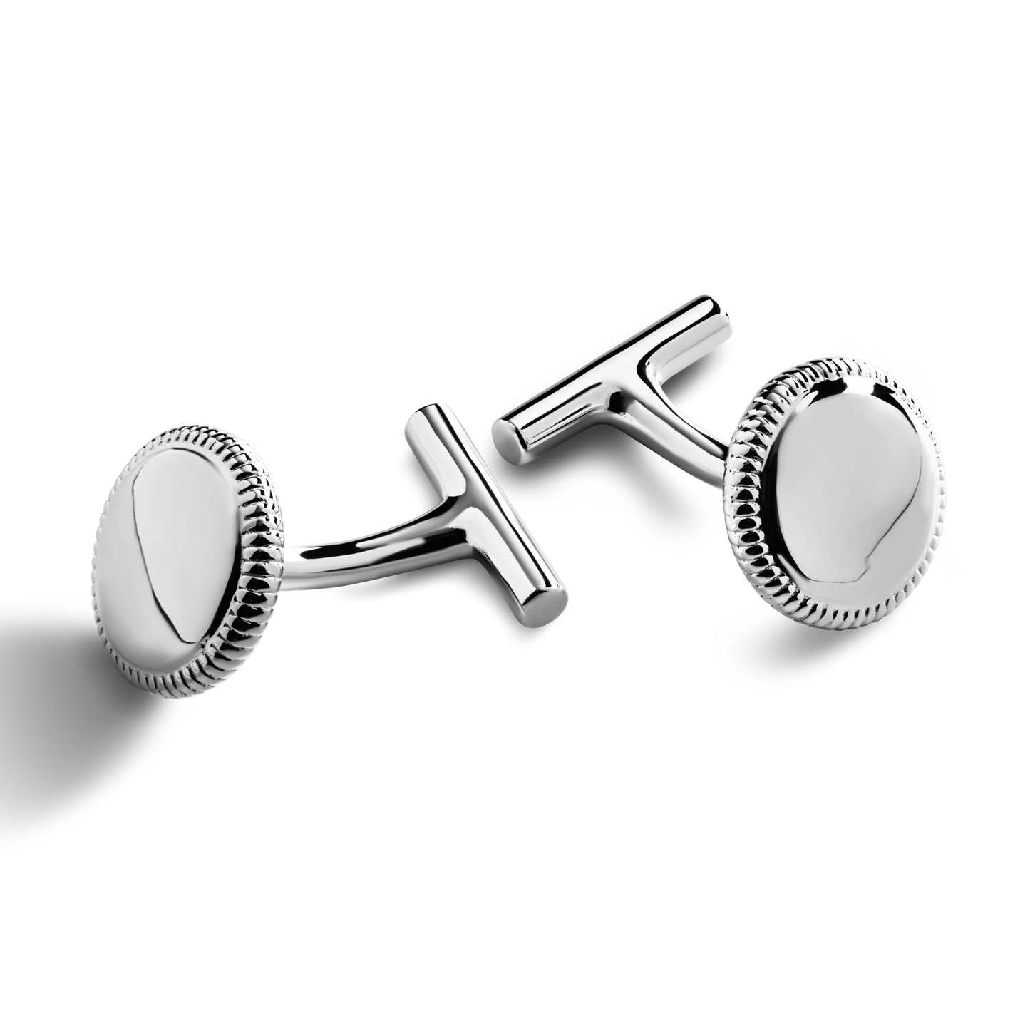 A pair of Shinola Coin Edge Cufflinks with round, sterling silver faces and textured edges is displayed on a white background.