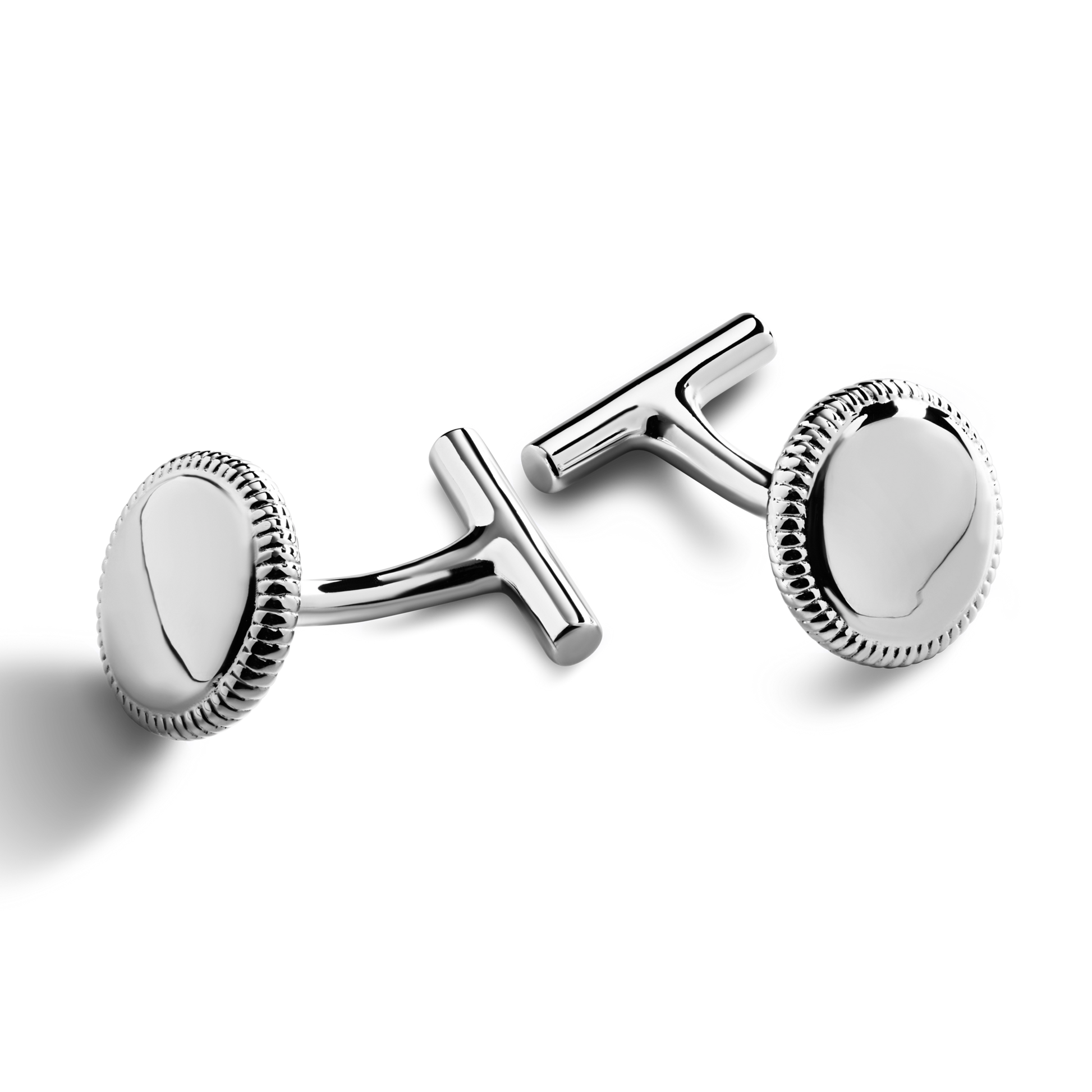 A pair of Shinola Coin Edge Cufflinks with round, sterling silver faces and textured edges is displayed on a white background.