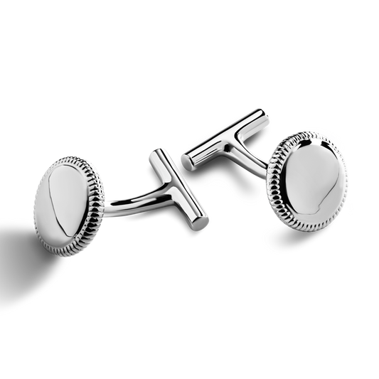 A pair of Shinola Coin Edge Cufflinks with round, sterling silver faces and textured edges is displayed on a white background.